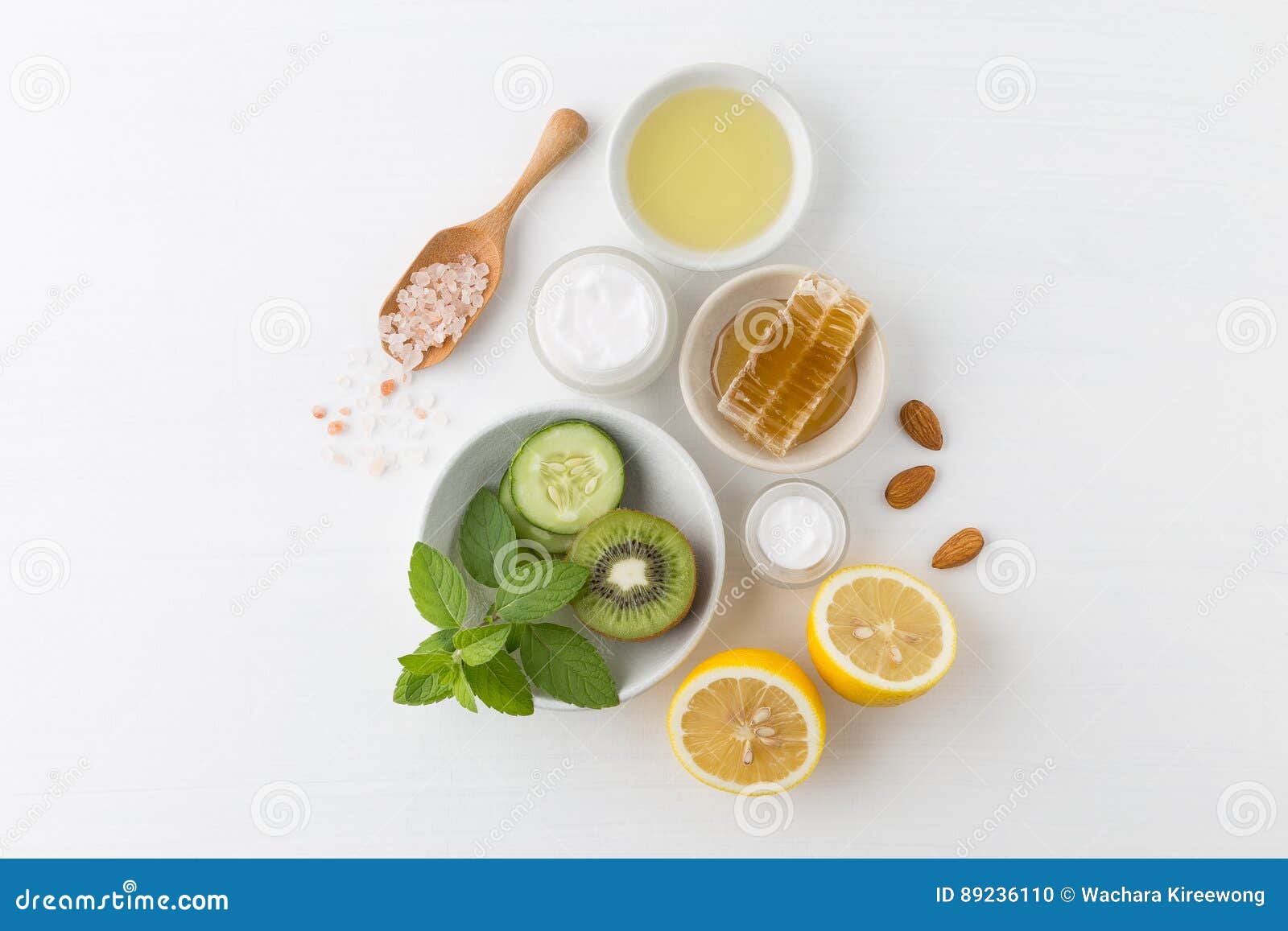 herbal dermatology cosmetic hygienic cream for beauty and skincare product. honey, lemon, kiwi, cucumber, salt, mint, oil on whit