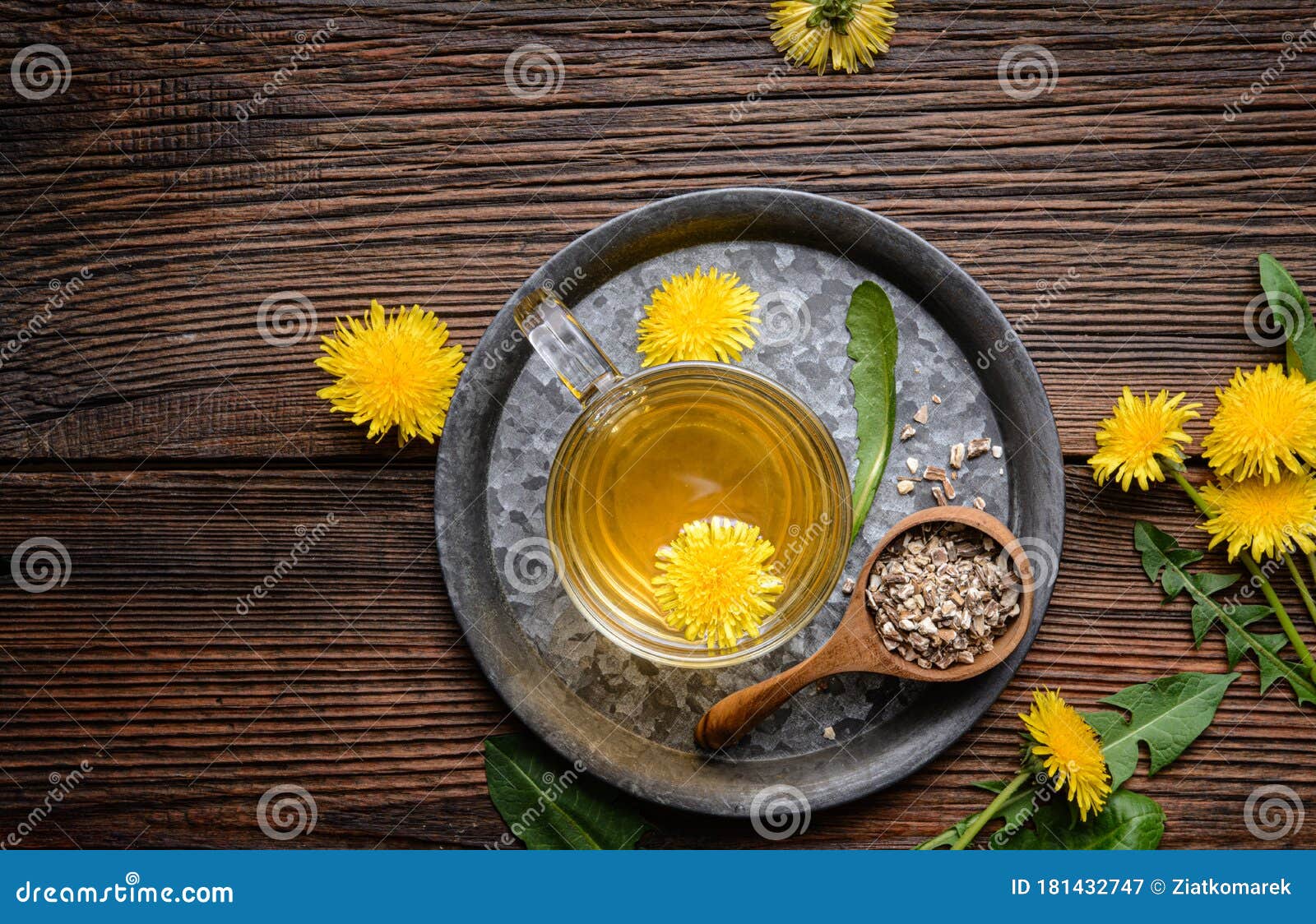herbal drink for liver detox, dandelion root tea in a glass cup decorated with fresh flowers with copy space
