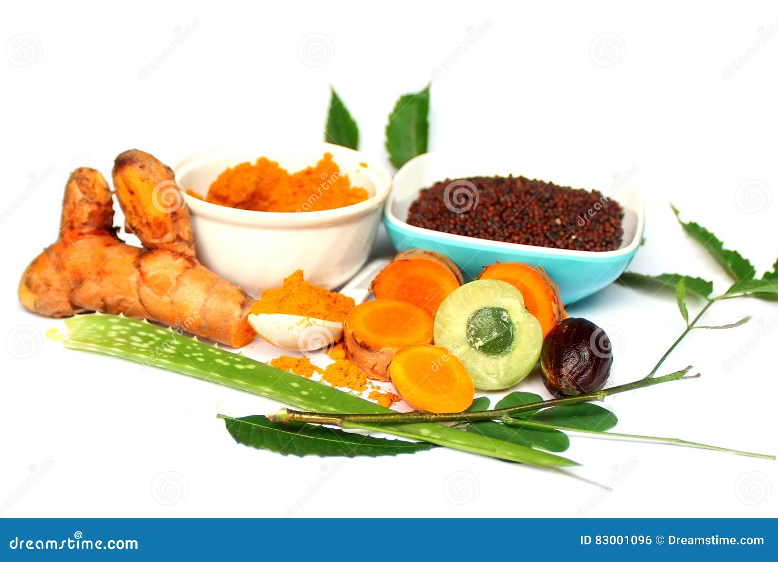 Raw Turmeric, Amla With Henna Powder And Henna Leaves Over White