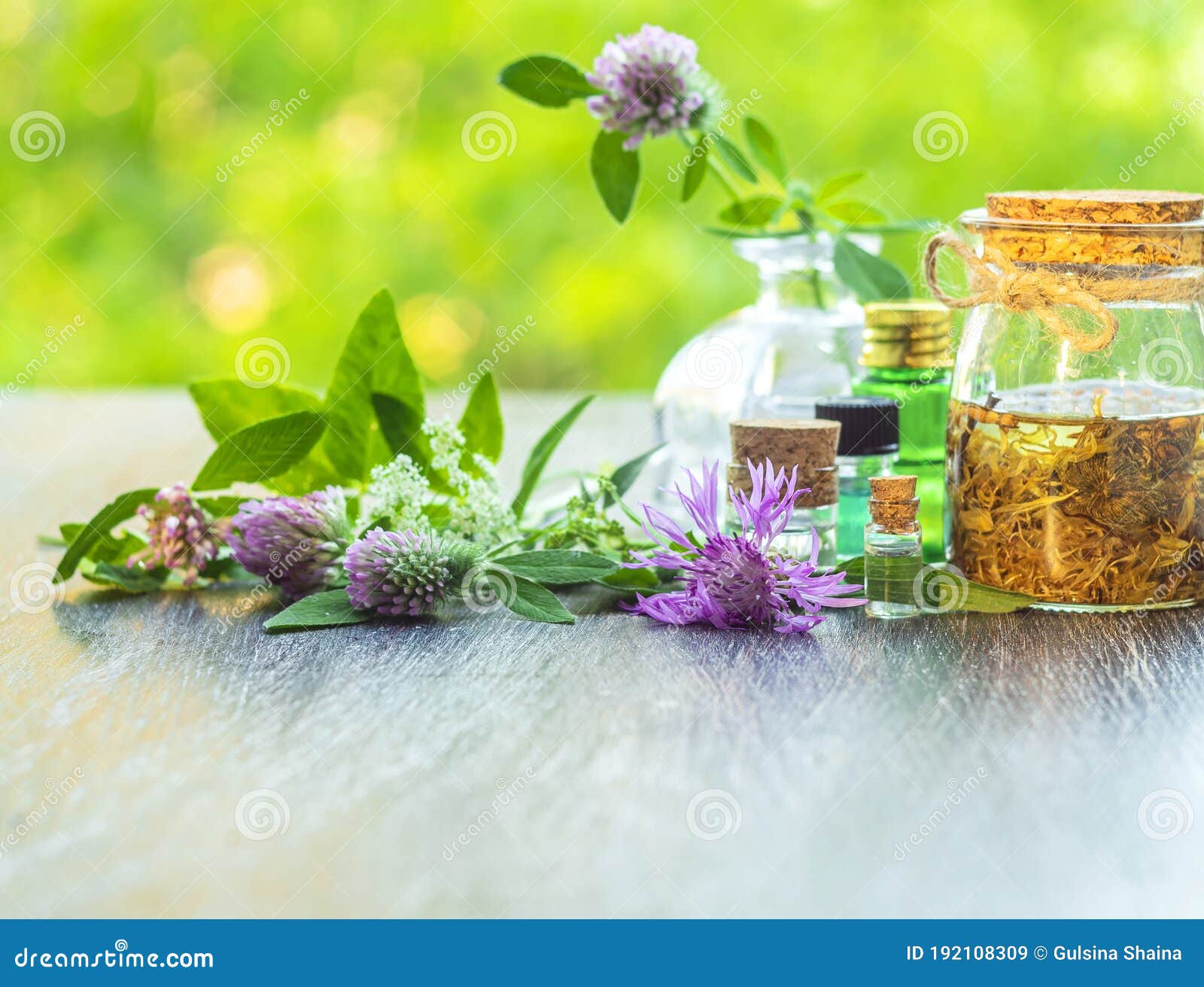herbs, bottles on wooden background. alternative medicine, natural healing