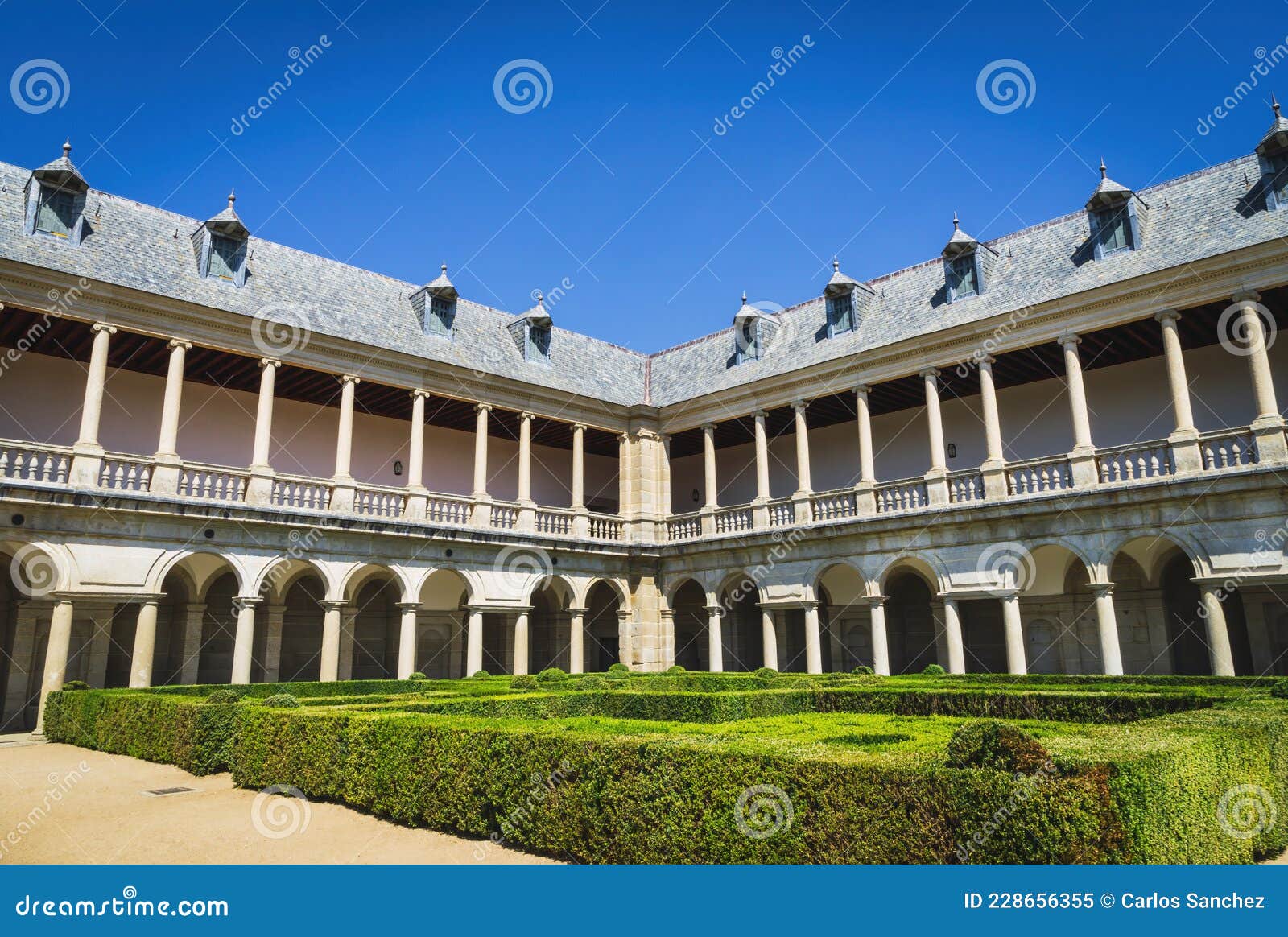 herrerian style cloister and part of the gardens of the monastery of san lorenzo de el escorial.