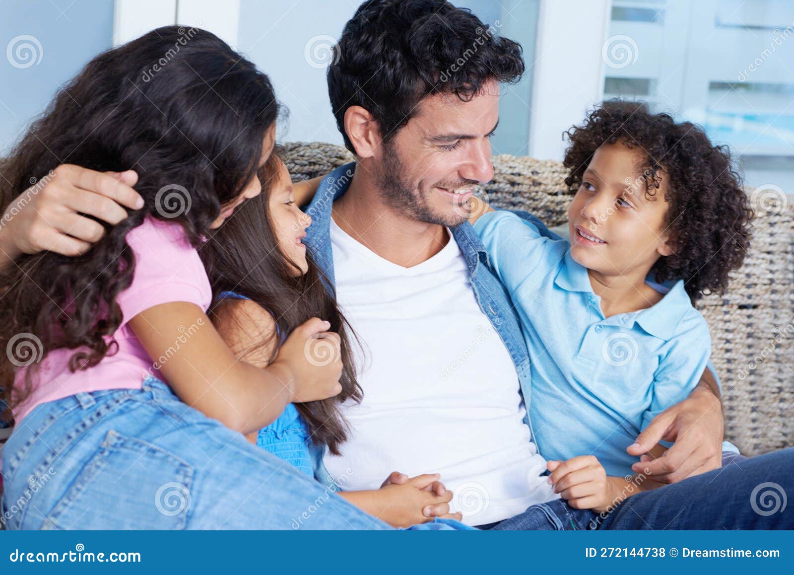 Hes Such a Devoted Father. a Happy Single Parent Family Sitting on a Sofa and Smiling at Each