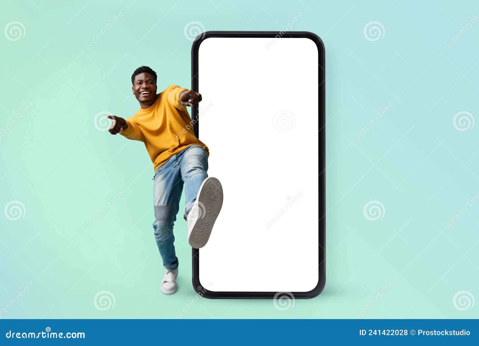 hey you, check this website. excited black man standing near huge smartphone with blank screen, mock up