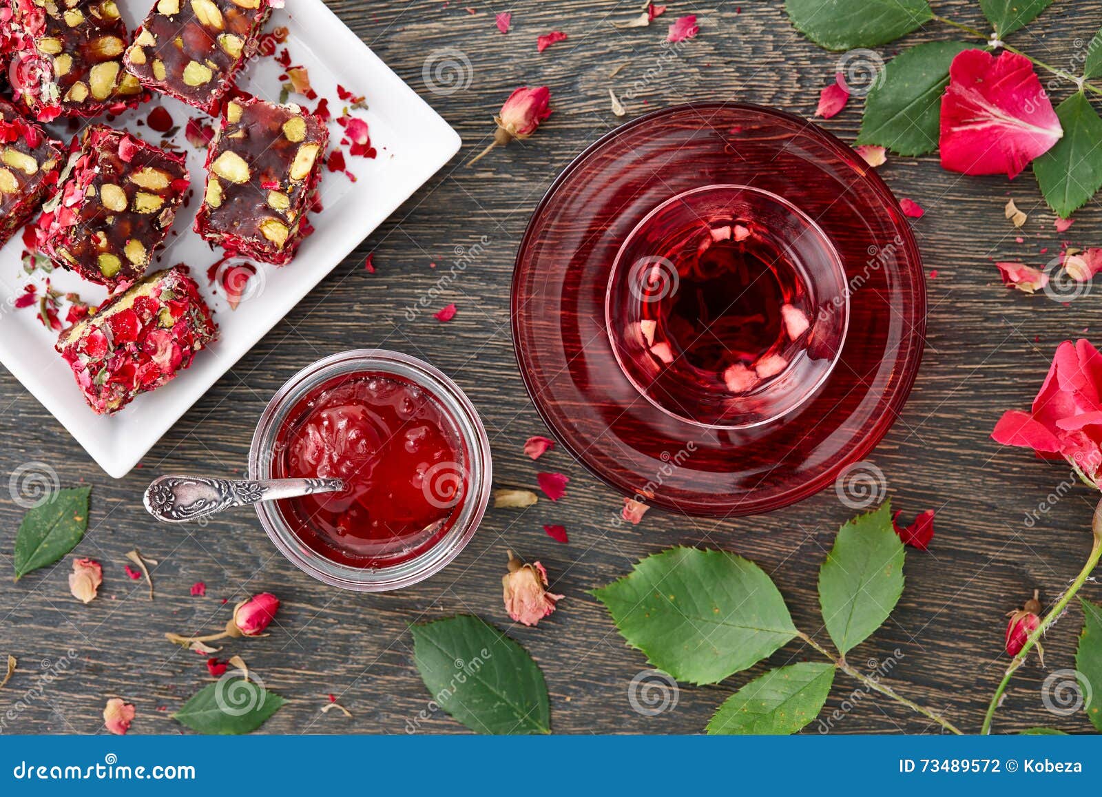 hibiscus-tea-rose-jam-turkish-delight-glass-cup-fruit-pieces-petals-dark-wooden-background-73489572.jpg