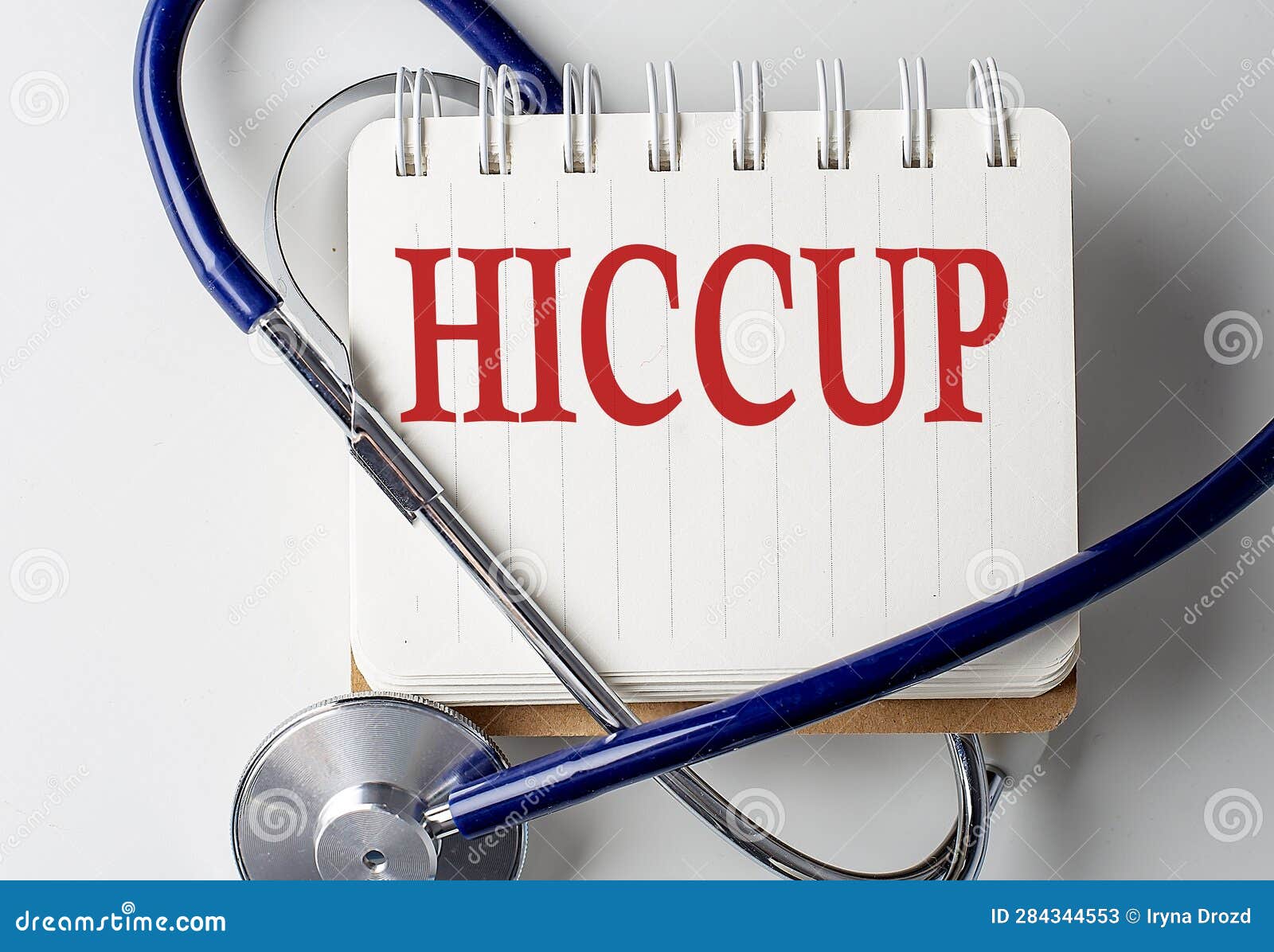HICCUP Word on Notebook with Medical Equipment on Background Stock