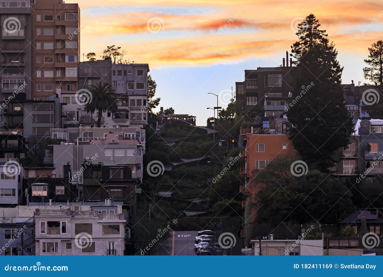 high angle the famous crooked lombard street in san francisco california with a cable car at on the hill at sunset