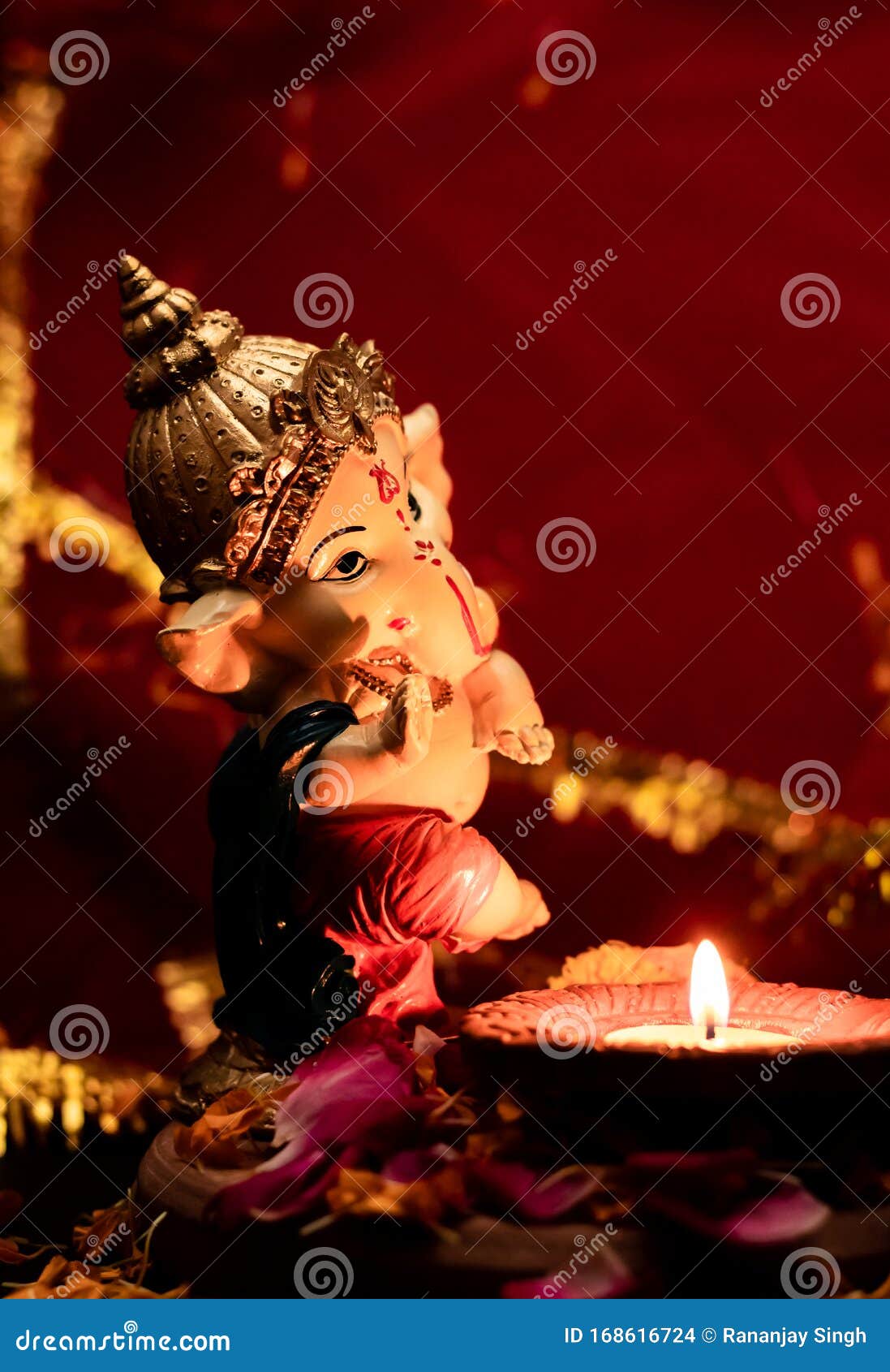 High Angle Mid Close Up of Beautiful Small Statue of Ganpati with ...
