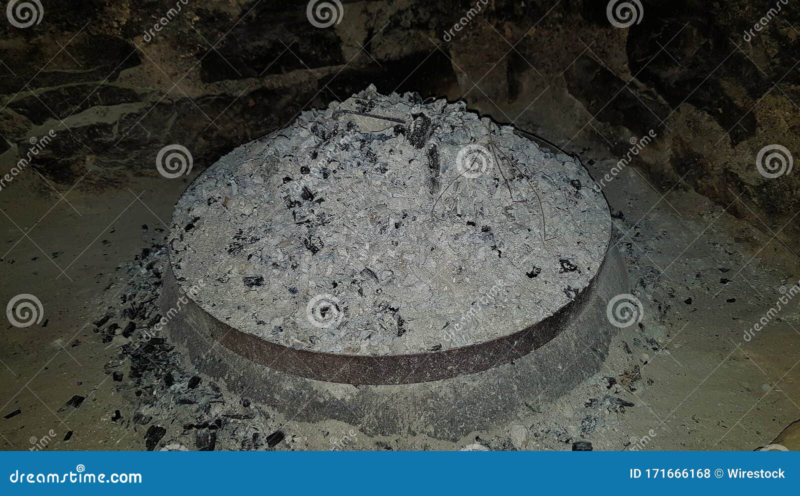 High Angle Shot of an Elevated Cooking Fire Pit Full of Ashes and
