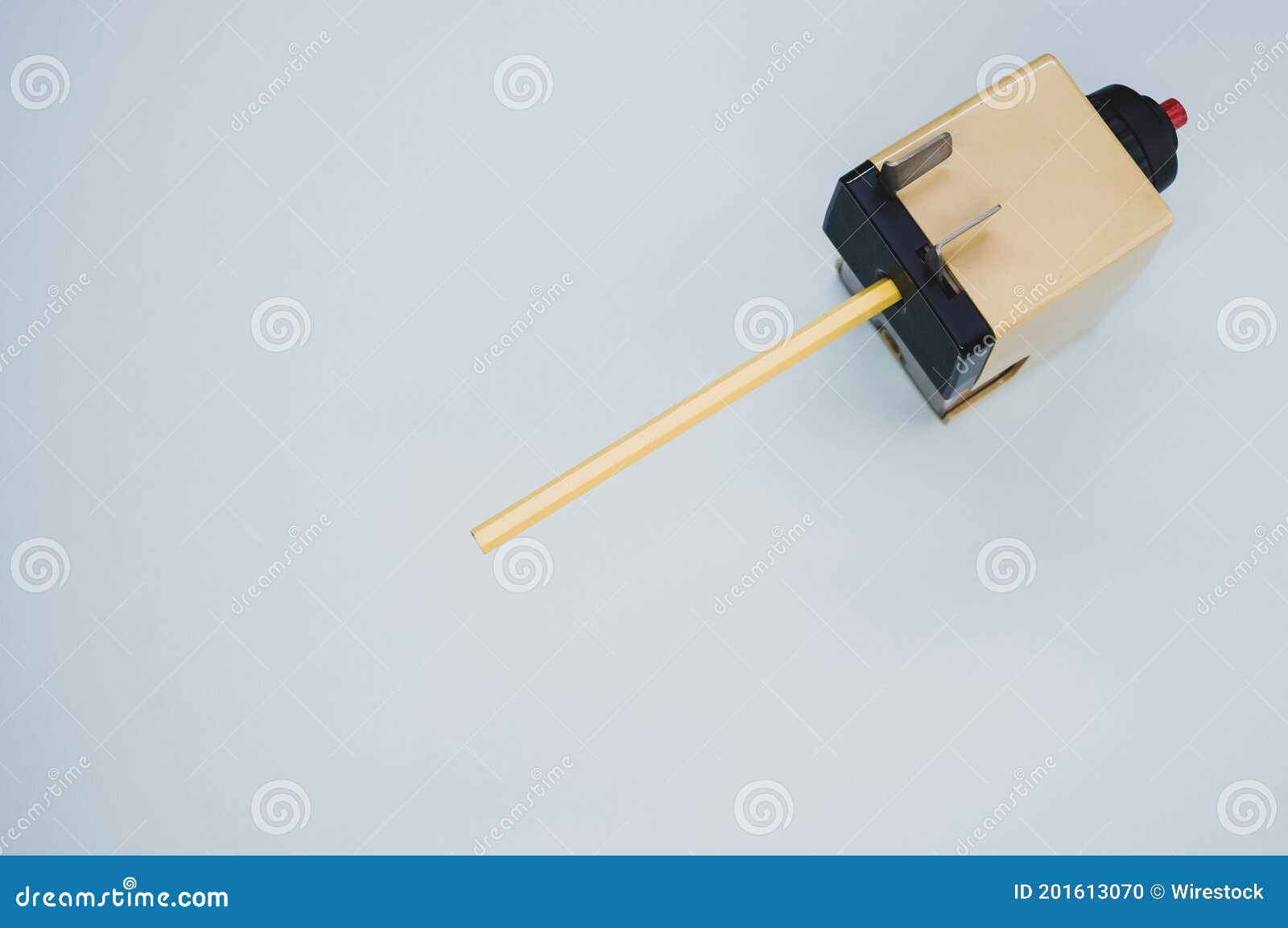 High Angle Shot of a Mechanical Pencil Sharpener on a Blue Surface