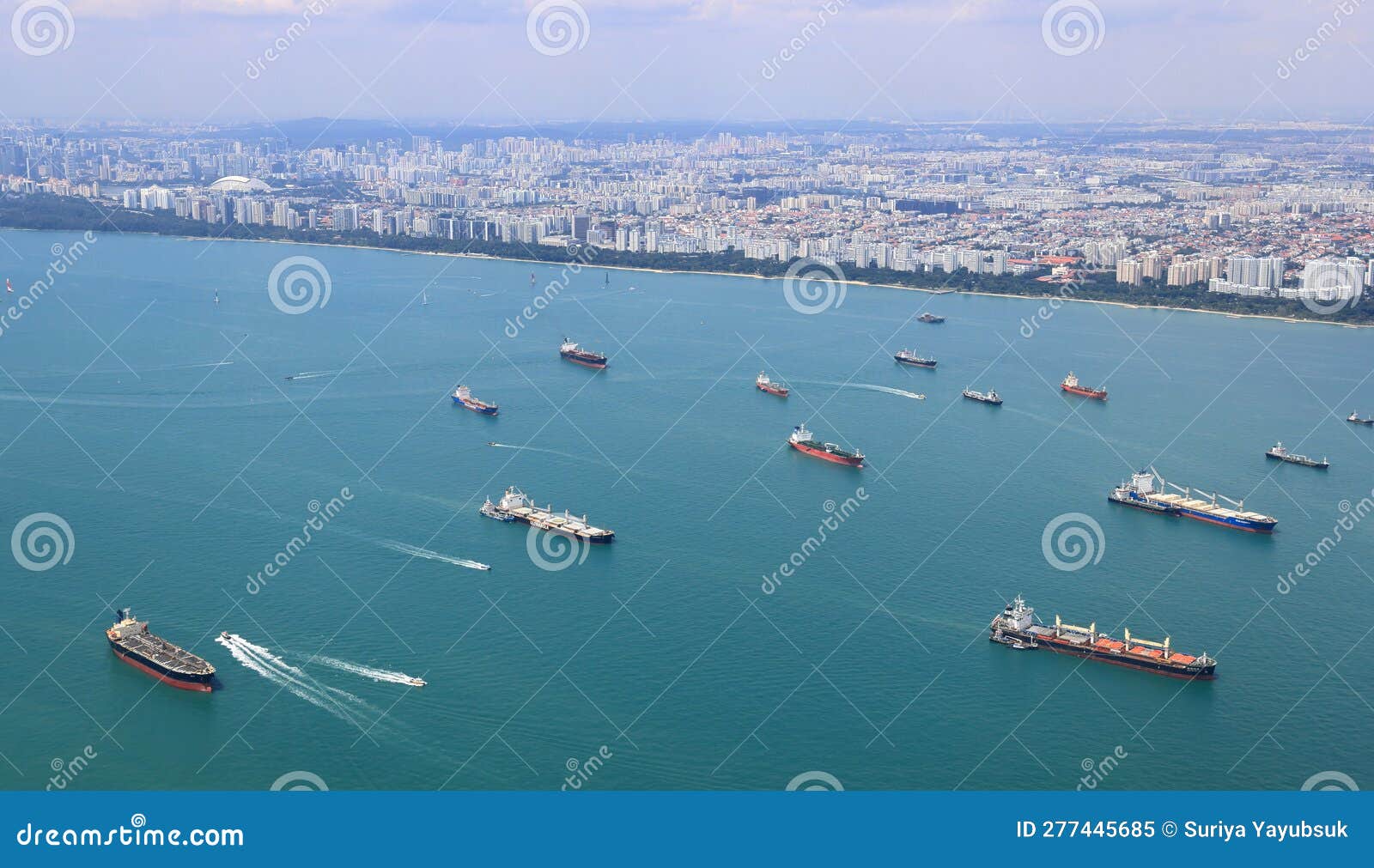 ocean liner, tanker and cargo ship in singapore strait and singapore city, see from plane.