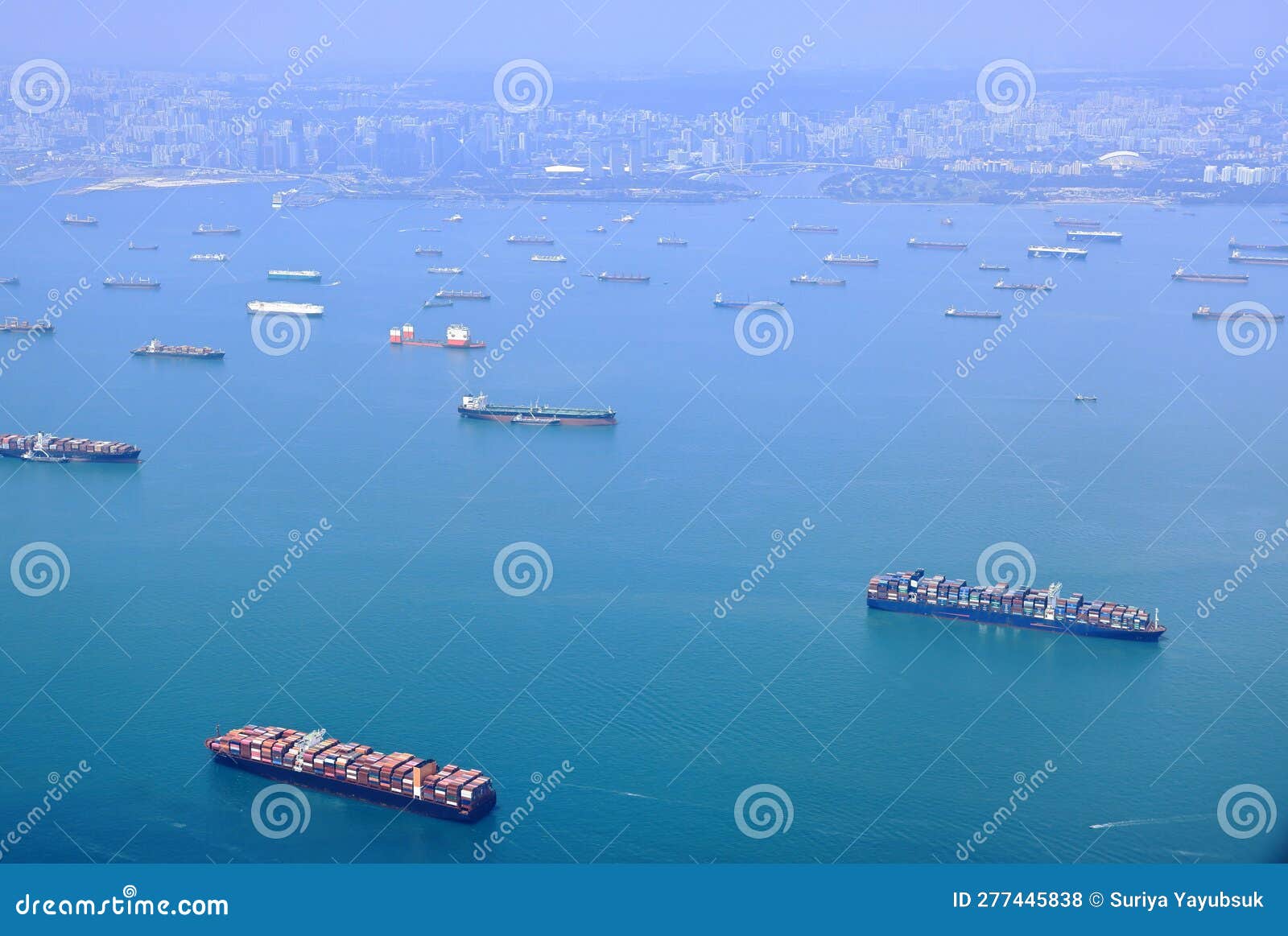 high angle shot of ocean liner, tanker and cargo ship in singapore strait.