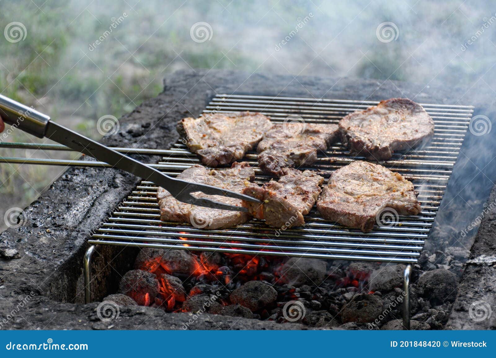 High Angle Shot of Steaks Cooking on a Flaming Grill Stock Photo