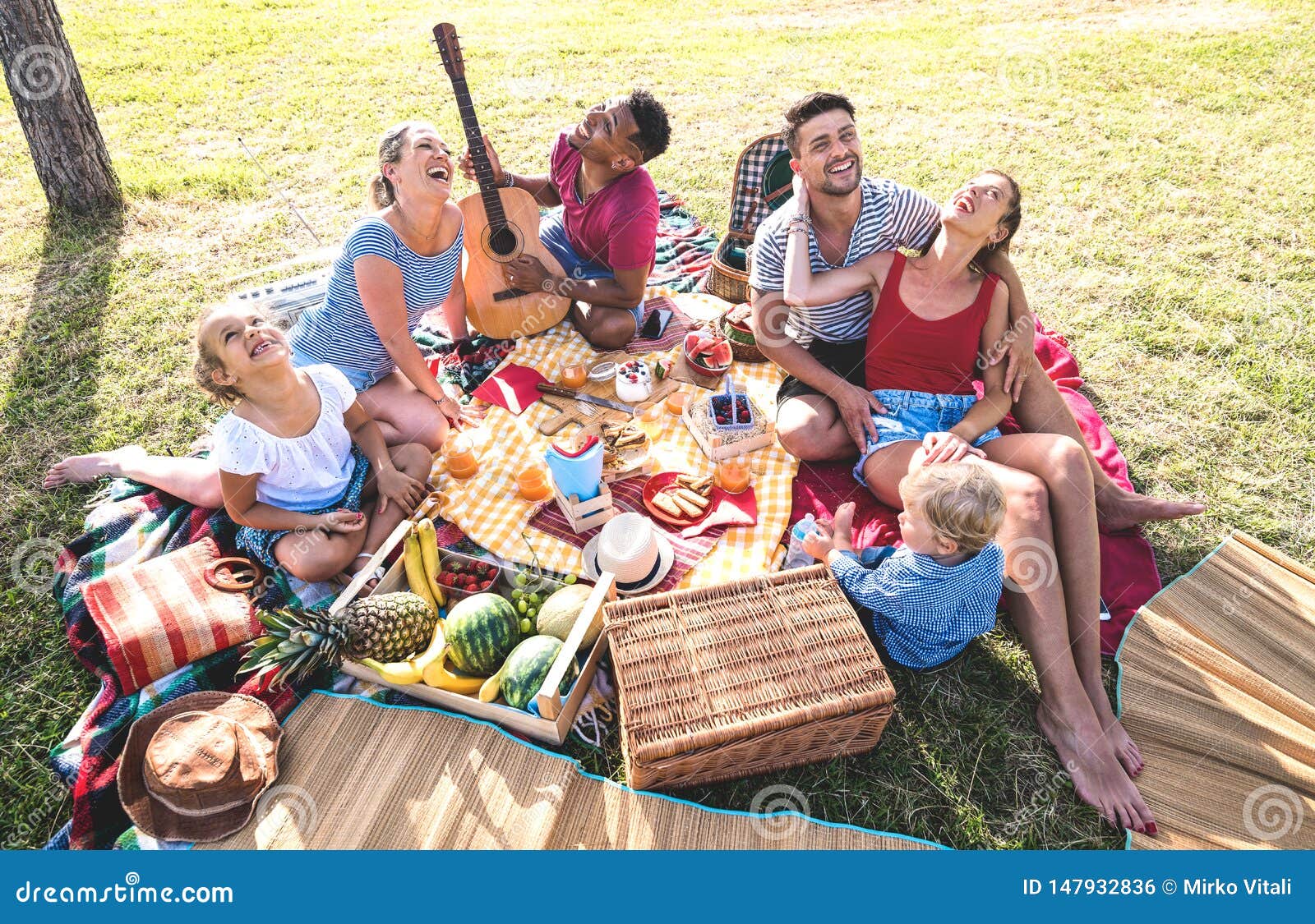 high angle top view of happy families having fun with kids at pic nic barbecue party - multiracial love concept
