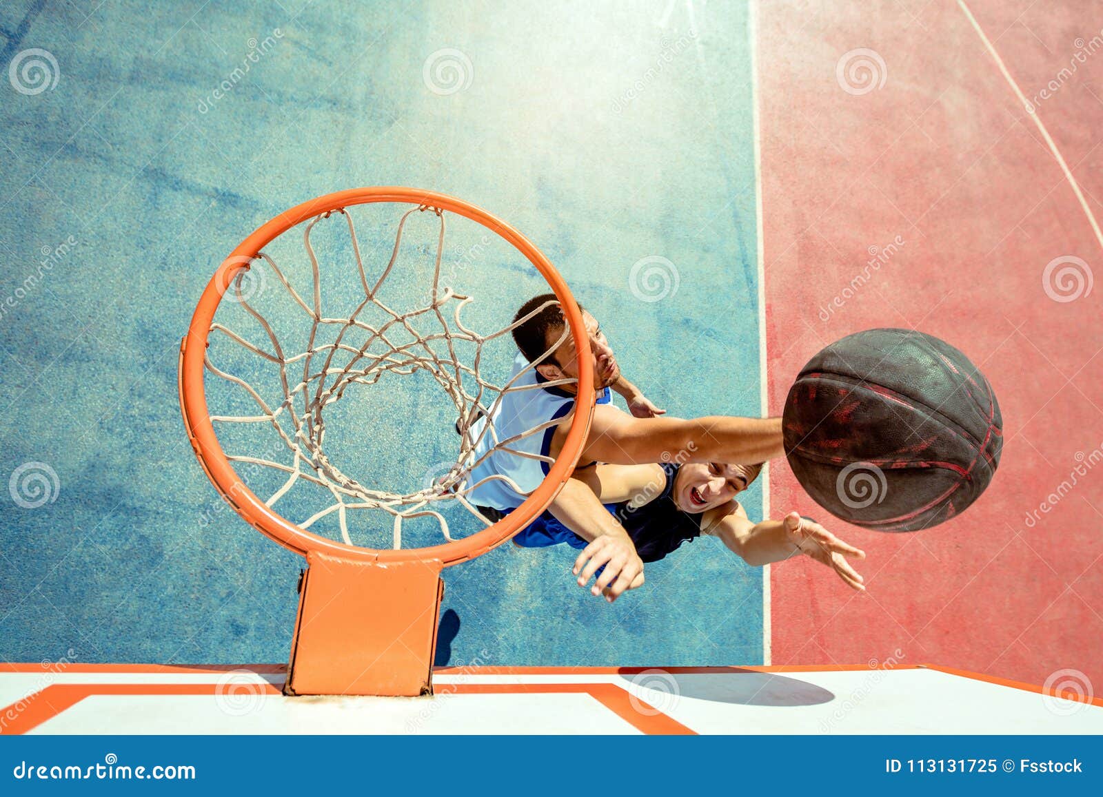 High Angle View of Basketball Player Dunking Basketball in Hoop Stock