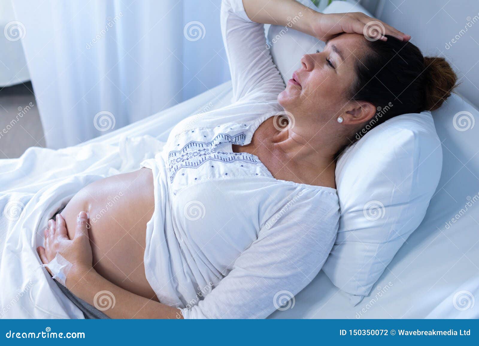 Pregnant Woman Suffering From Pain While Touching Her Belly I