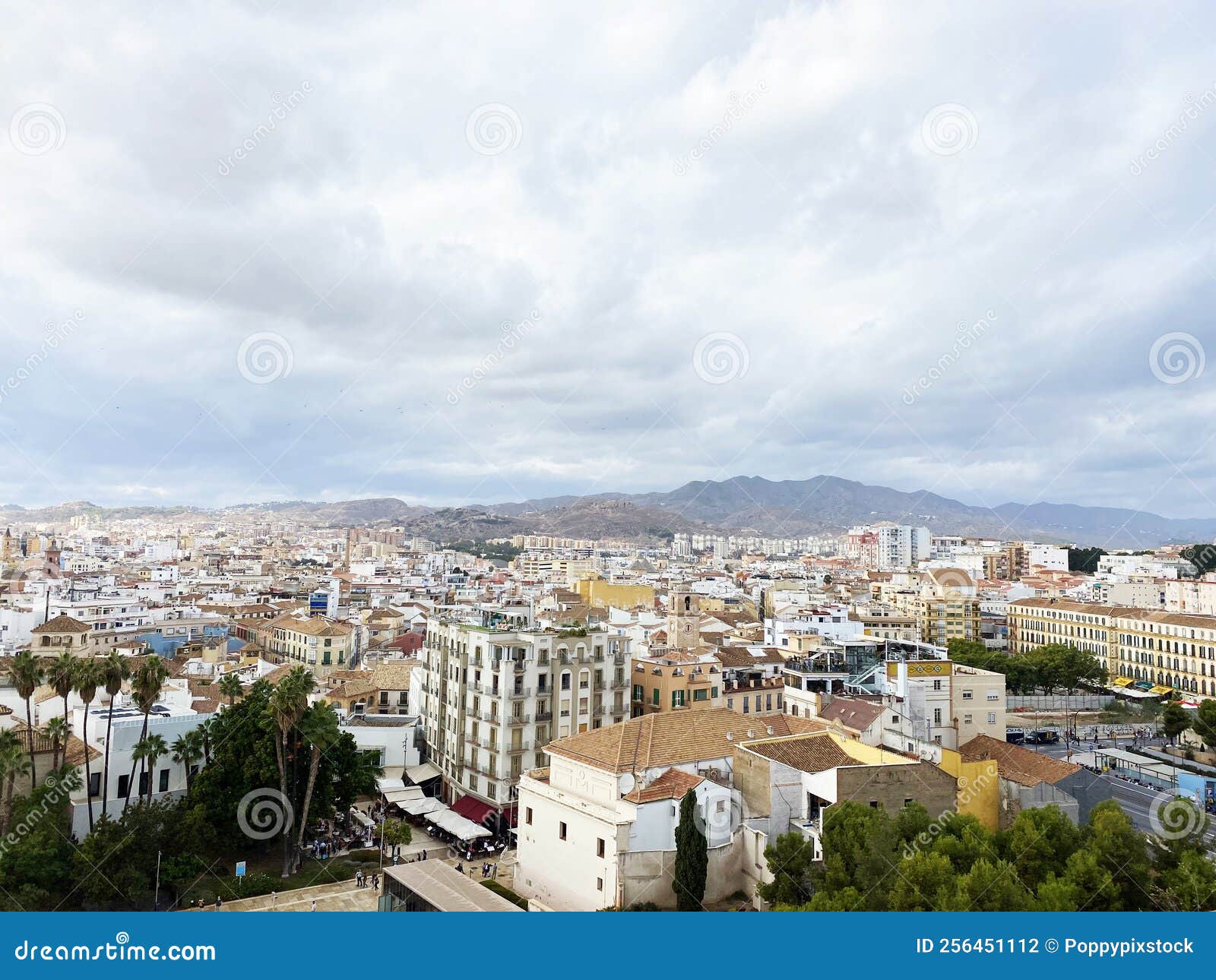 high angle view of the city from alcazaba de malaga on a cloudy day. one of the most famous attractions in malaga, spain