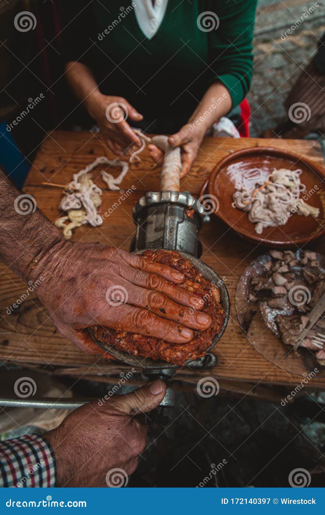 High Angle View of People Grinding Meat for a Kielbasa with an Old