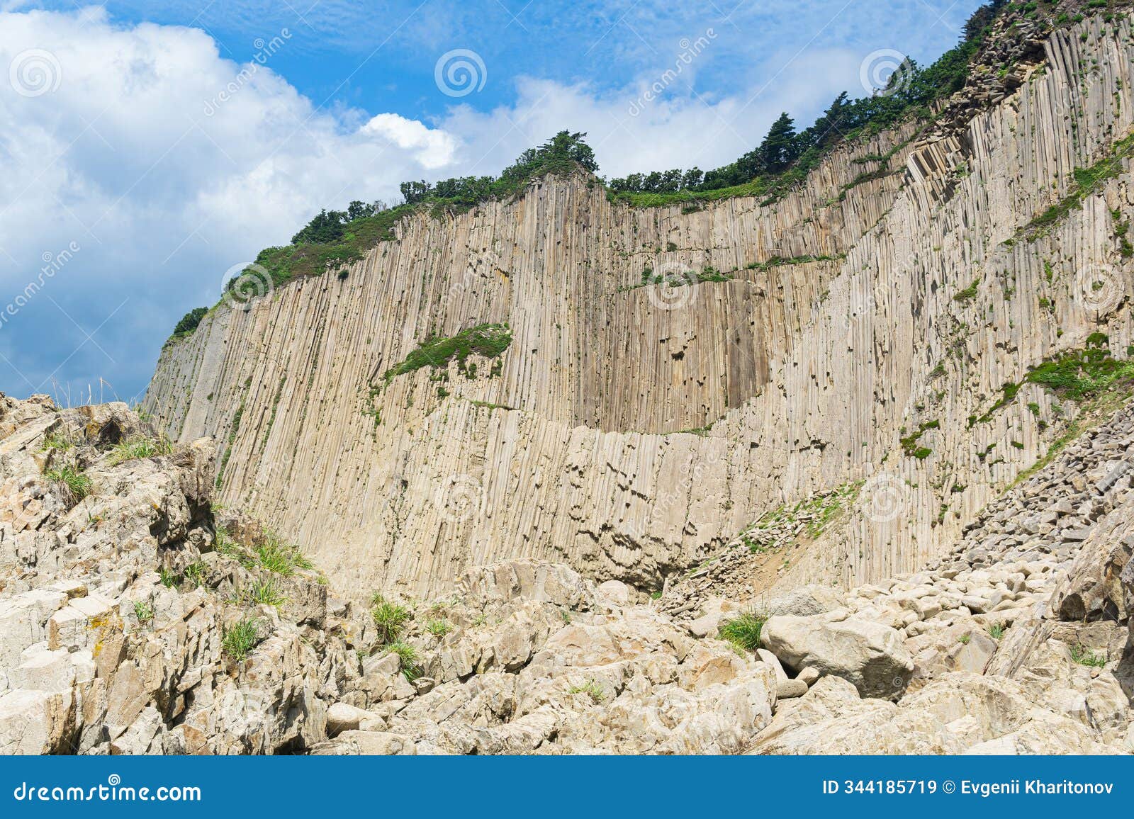 high coastal cliff formed by solidified lava stone columns, cape stolbchaty on kunashir island