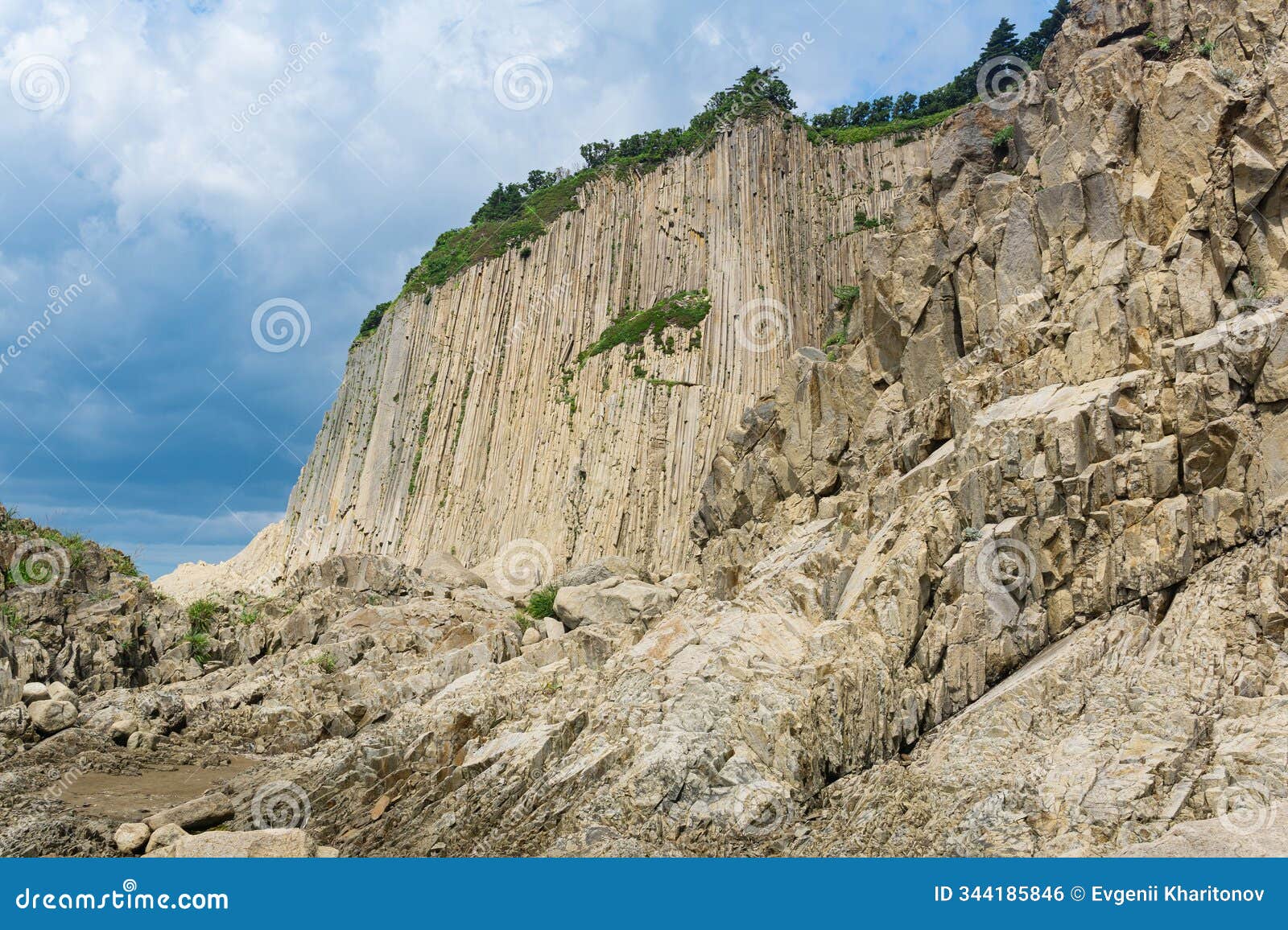 high coastal cliff formed by solidified lava stone columns, cape stolbchaty on kunashir island