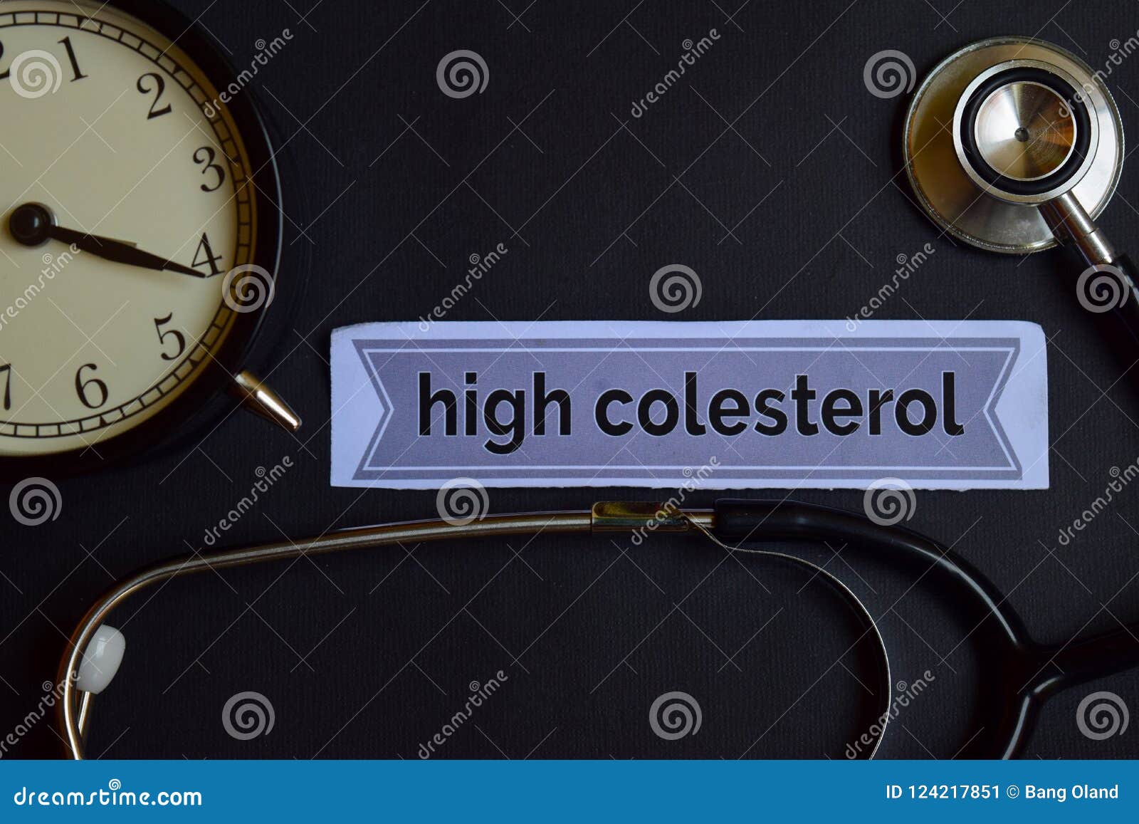 high colesterol on the print paper with healthcare concept inspiration. alarm clock, black stethoscope.
