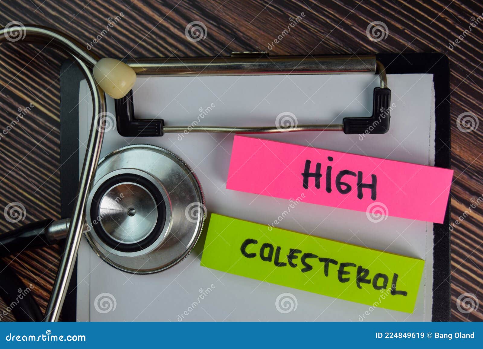 high colesterol write on sticky notes  on wooden table. medical or healthcare concept