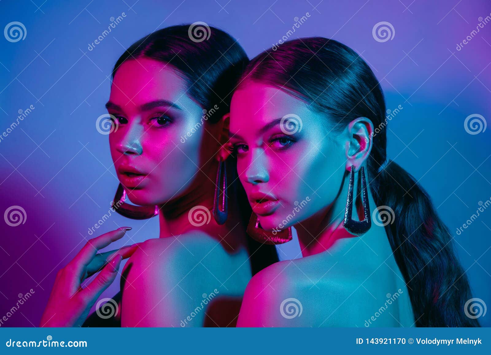 high fashion models in colorful bright neon lights posing at studio