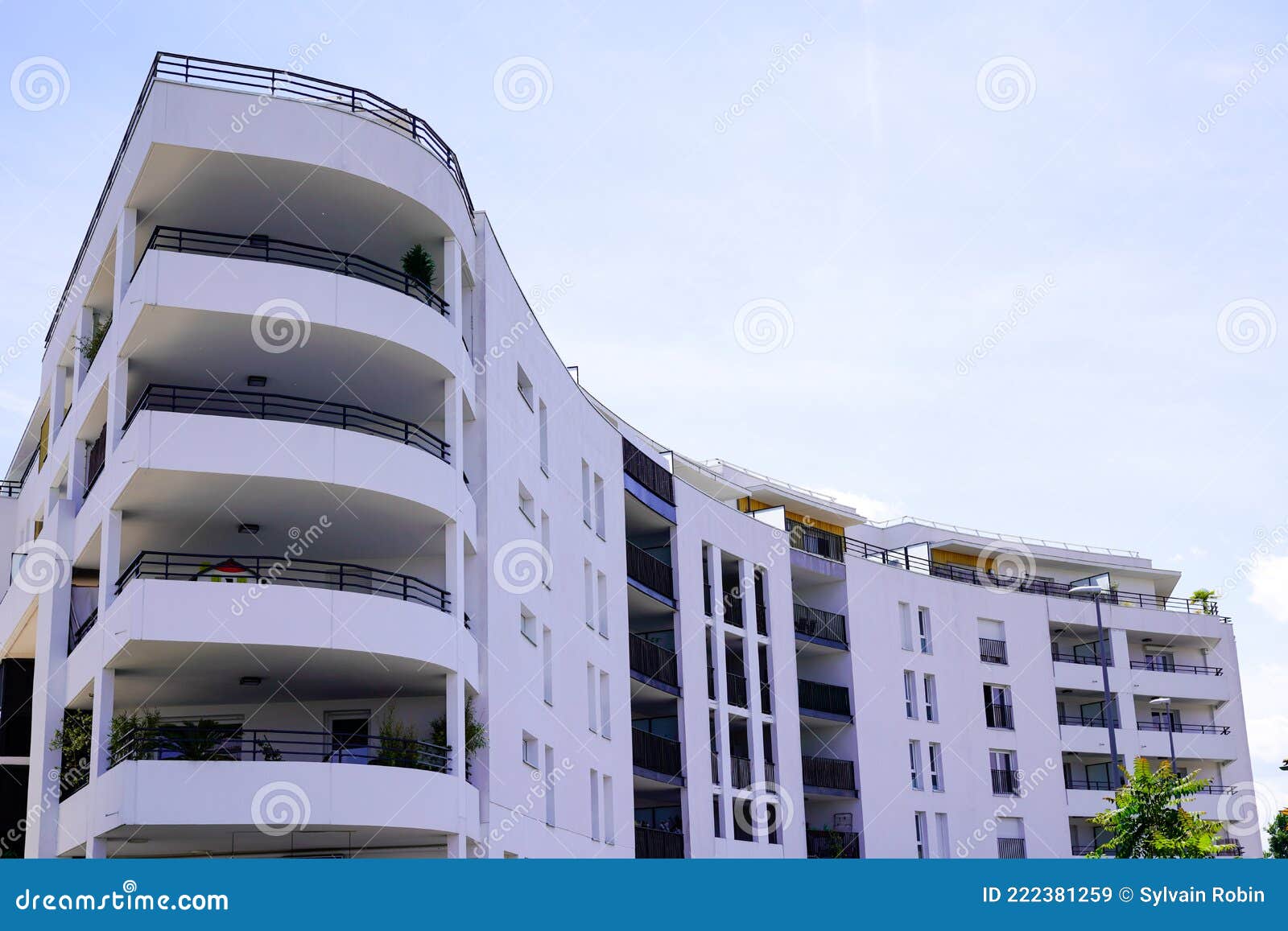High Modern White Facade Building with Balcony and Terrace in City