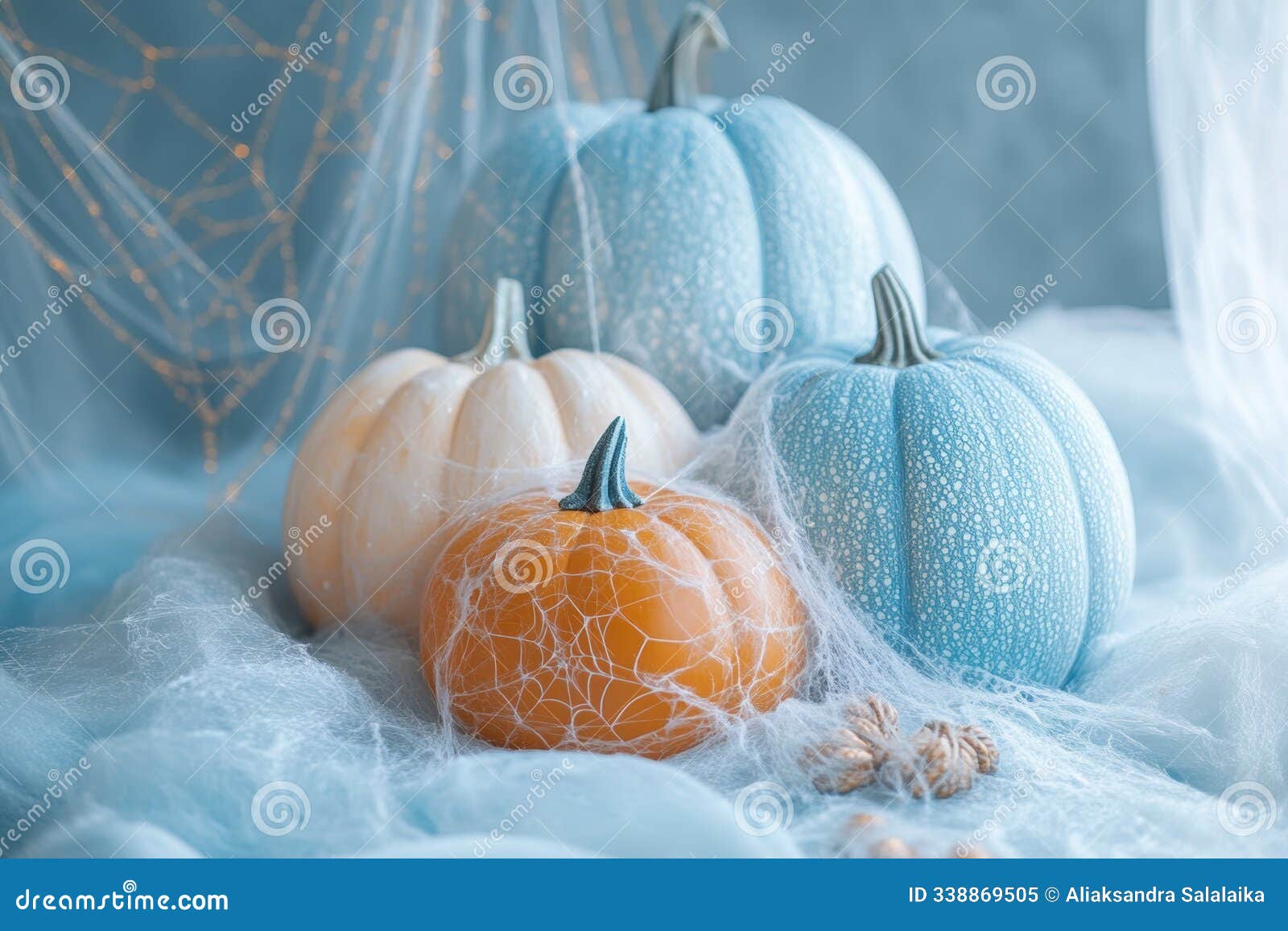 a sleek halloween look with blue and orange hints, featuring a simple spider web  and stylish pumpkin decor