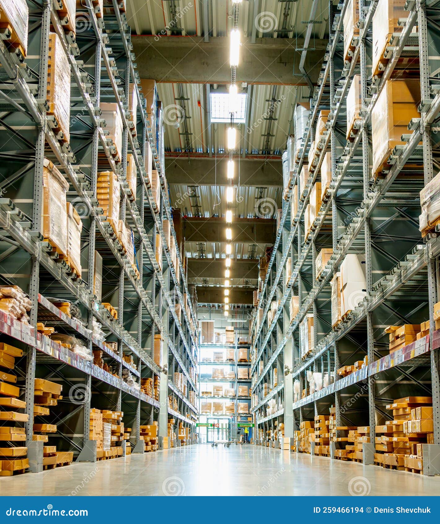 High Racks in the Aisle in a Large Warehouse Vertical View Stock Photo