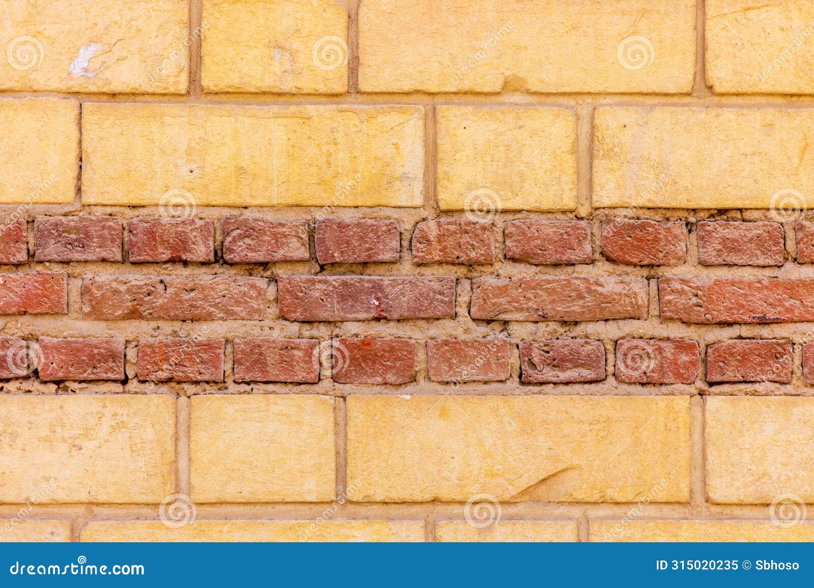 pale, semi smooth multi earth tones cream and central dark red regular horizontal limesto in egyptne wall