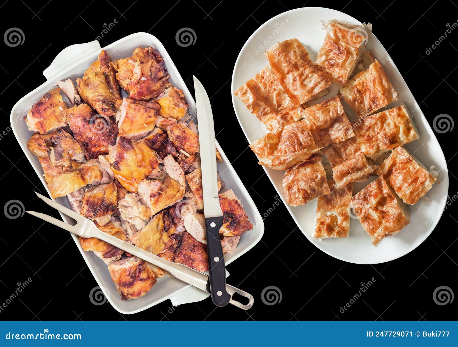 spit roasted pork meat and traditional serbian cheese pie gibanica in ceramic tray and casserole  on black background