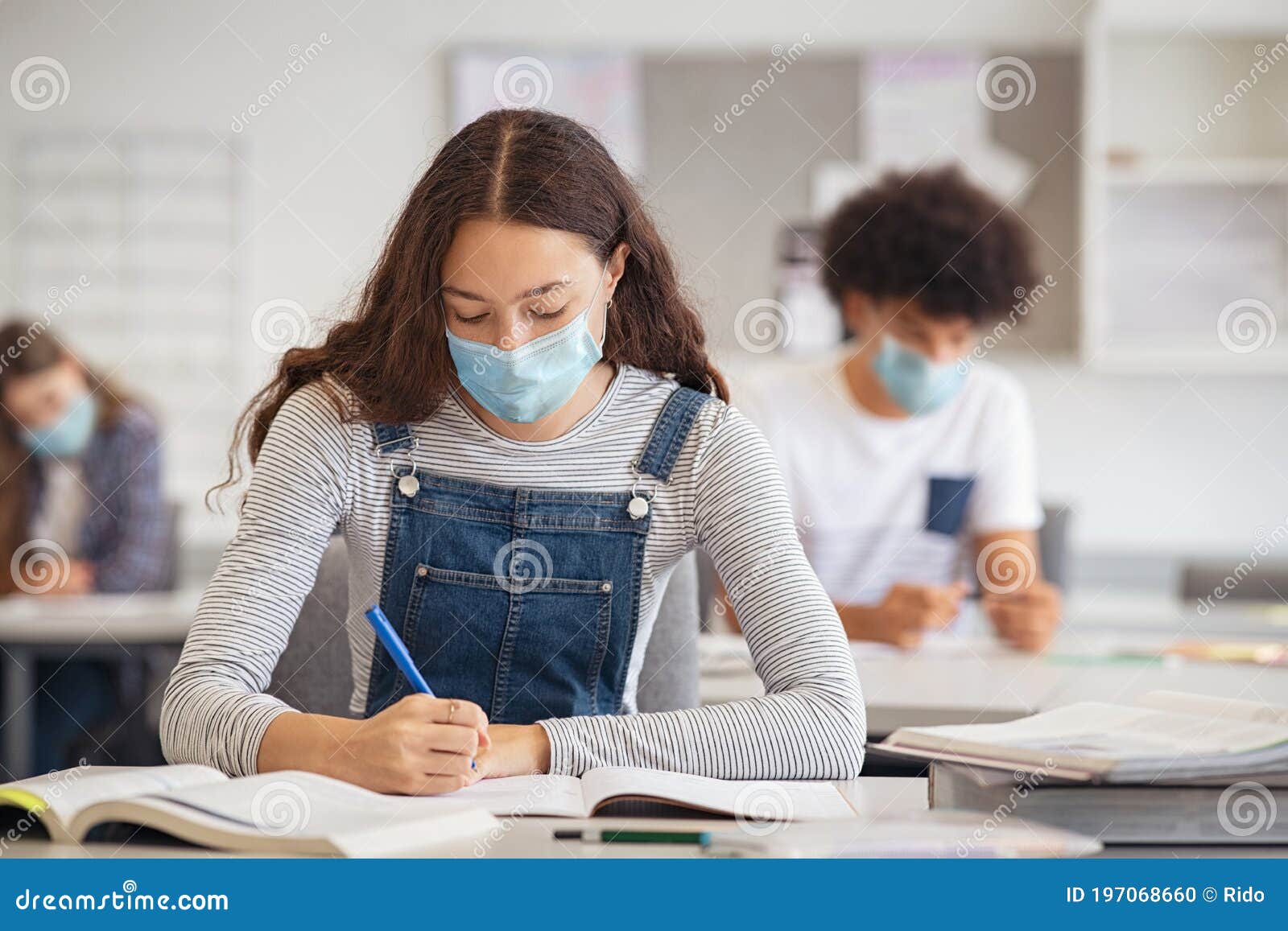 high school girl studying in class with face mask