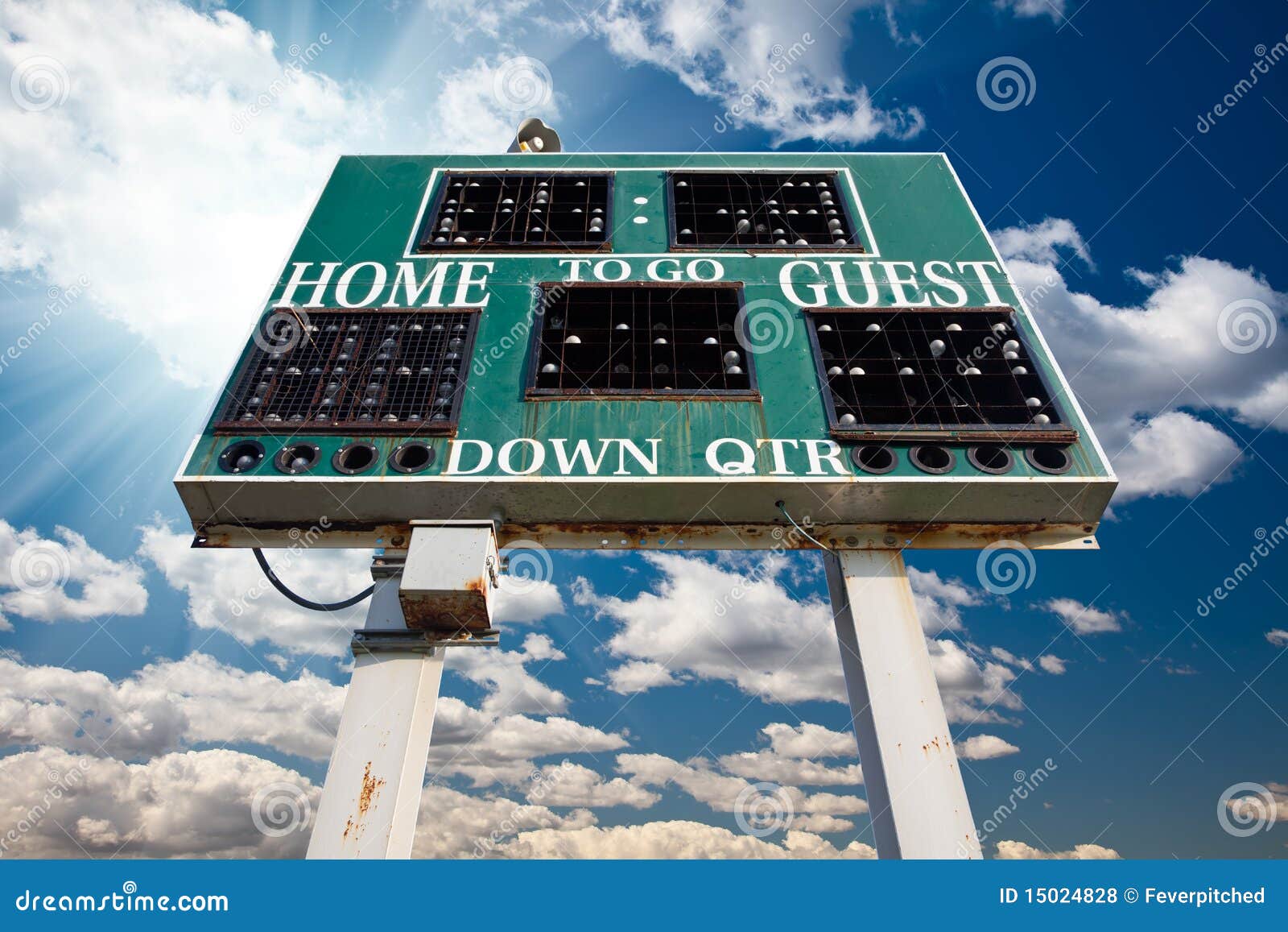 high school scoreboard over blue sky with clouds