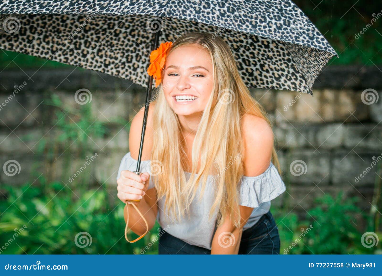 High school senior poses with umbrella for portraits on a rainy Stock Photo  | Adobe Stock