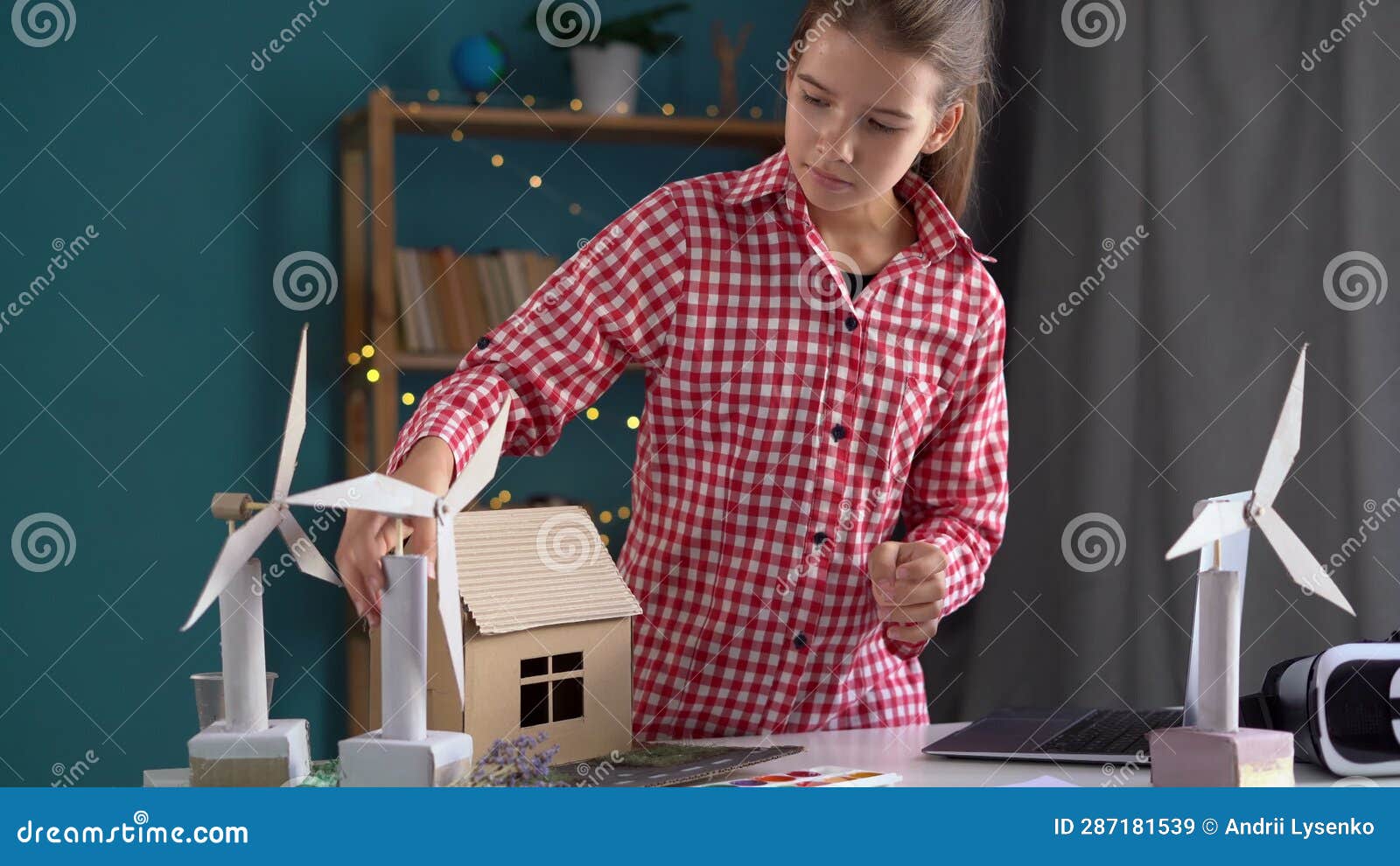 High School Student is Doing a Science Project Sitting at the Table at