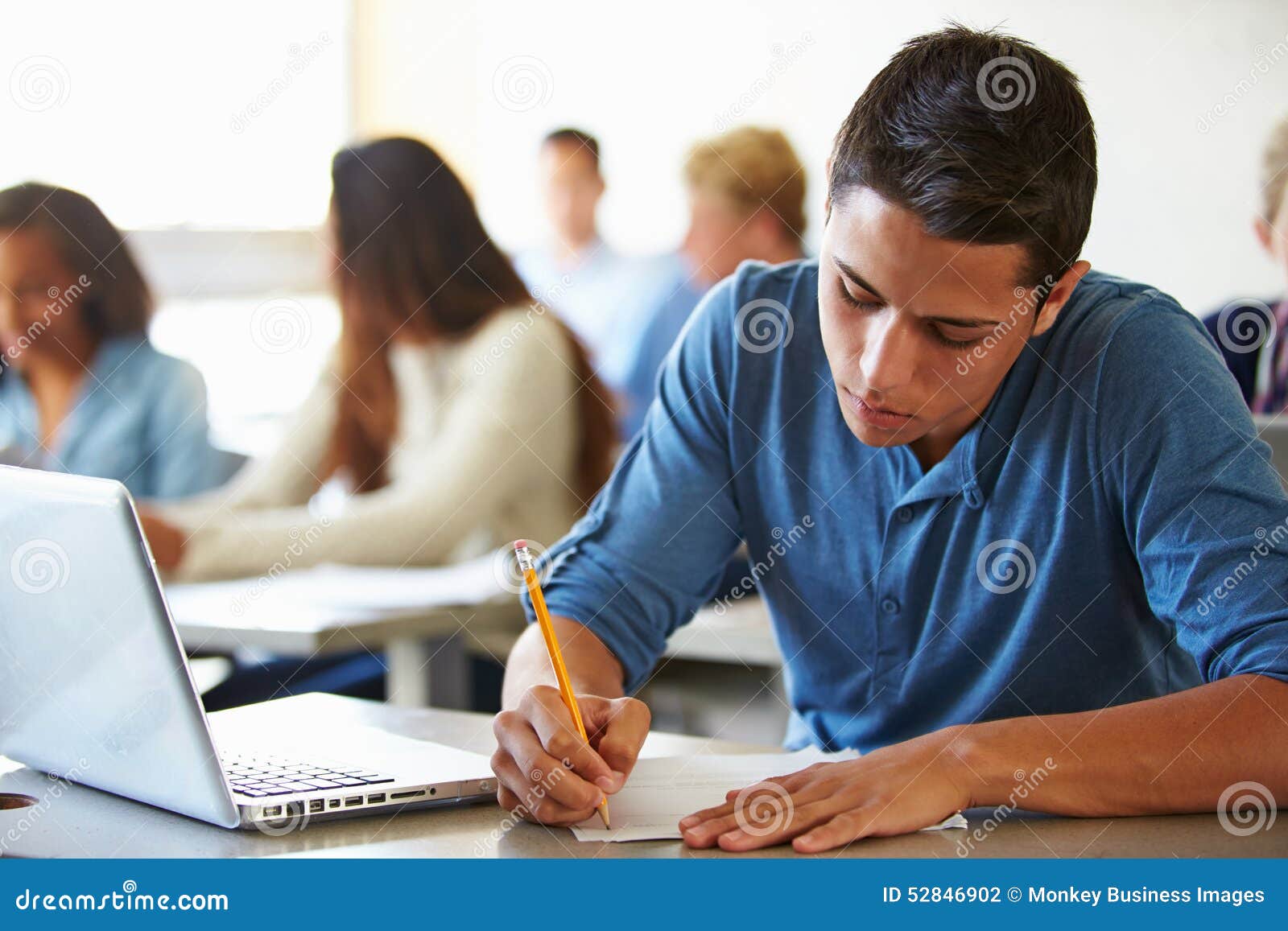 high school students taking test in classroom