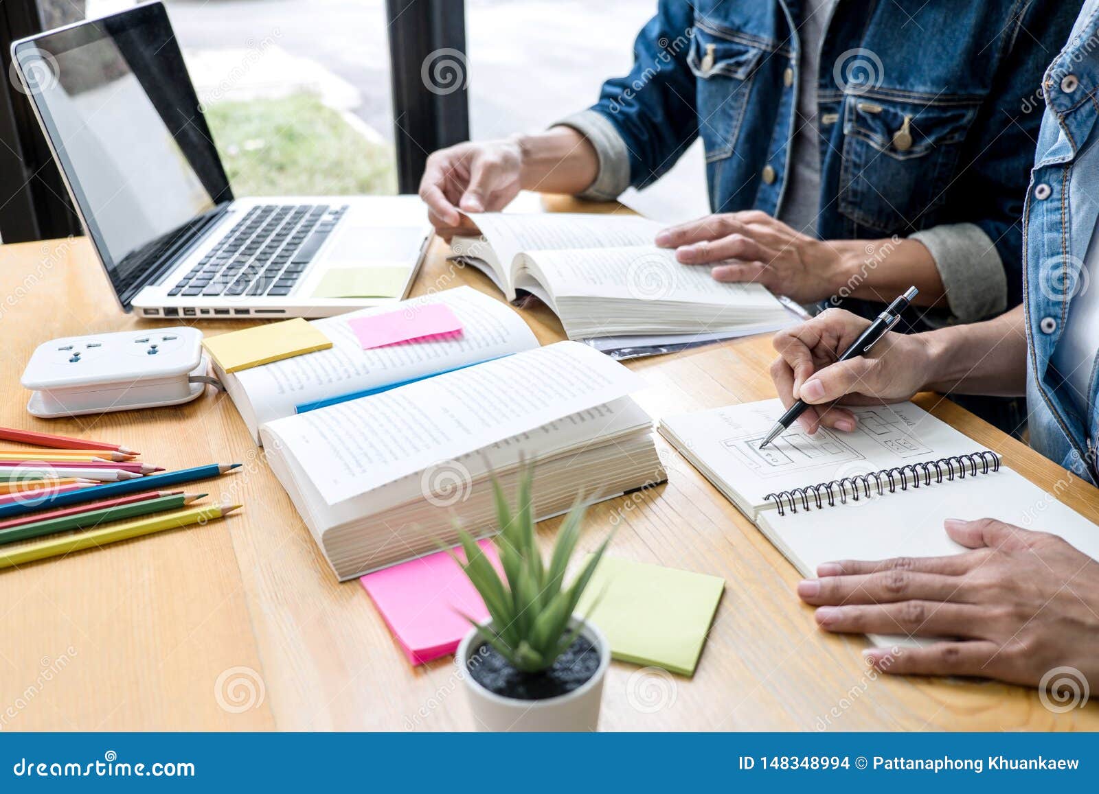High School Tutor Or College Student Group Sitting At Desk In