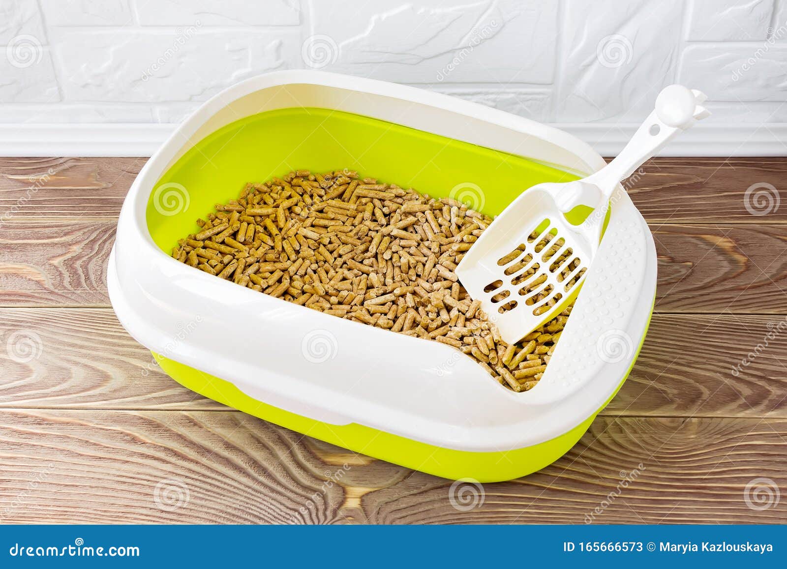 High Sided Cat Litter Tray With Wooden Pellets And Scoop On A Brown