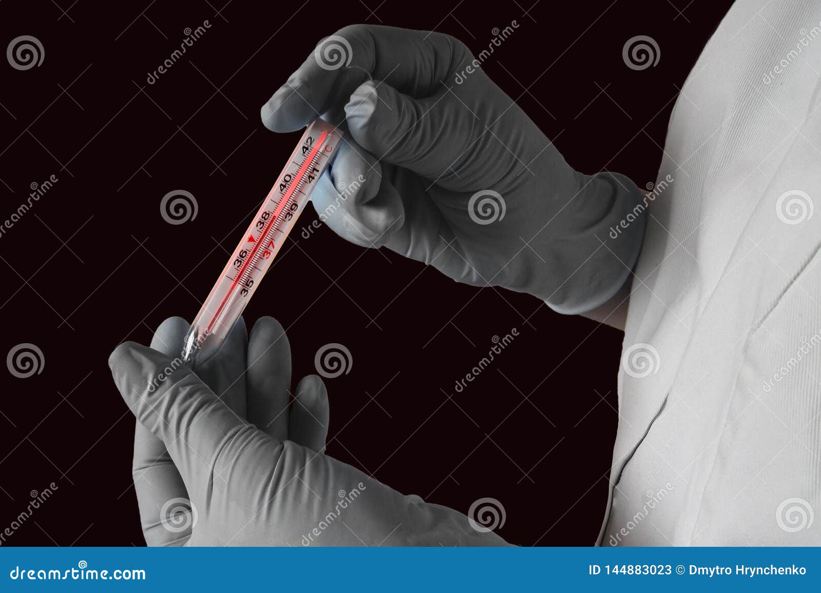 high temperature measurement. fever or flu virus epidemy concept. two hands in gloves hold a thermometer with hot red scale on