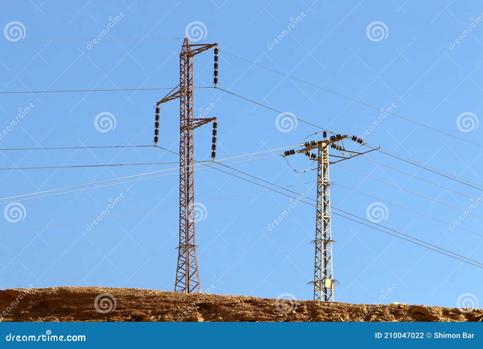 High Voltage Power Lines through Fields and Mountains in Israel Stock