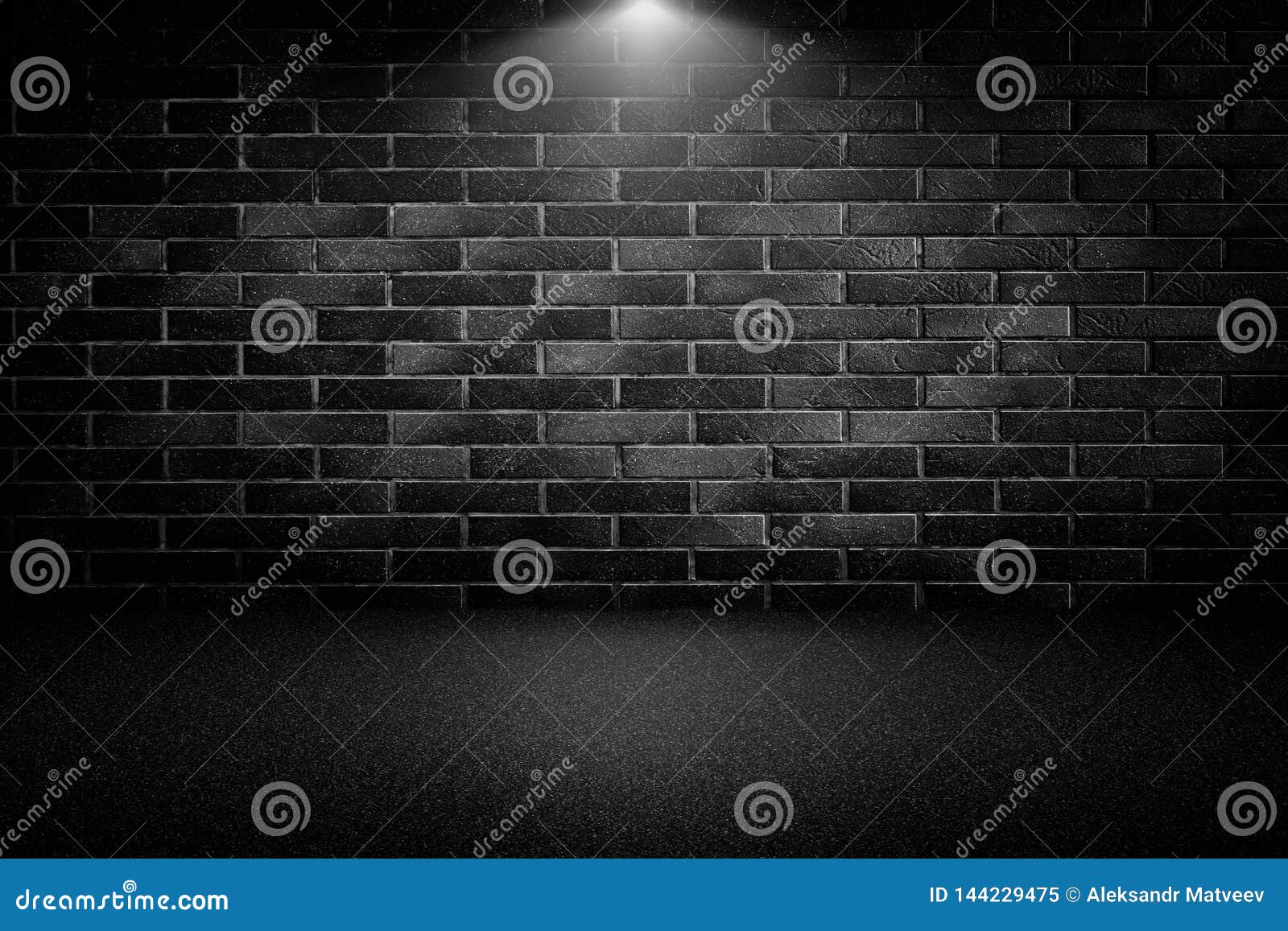 Highly Contrasted Spotlights on an Outdoor Black Brick Wall Stock Image