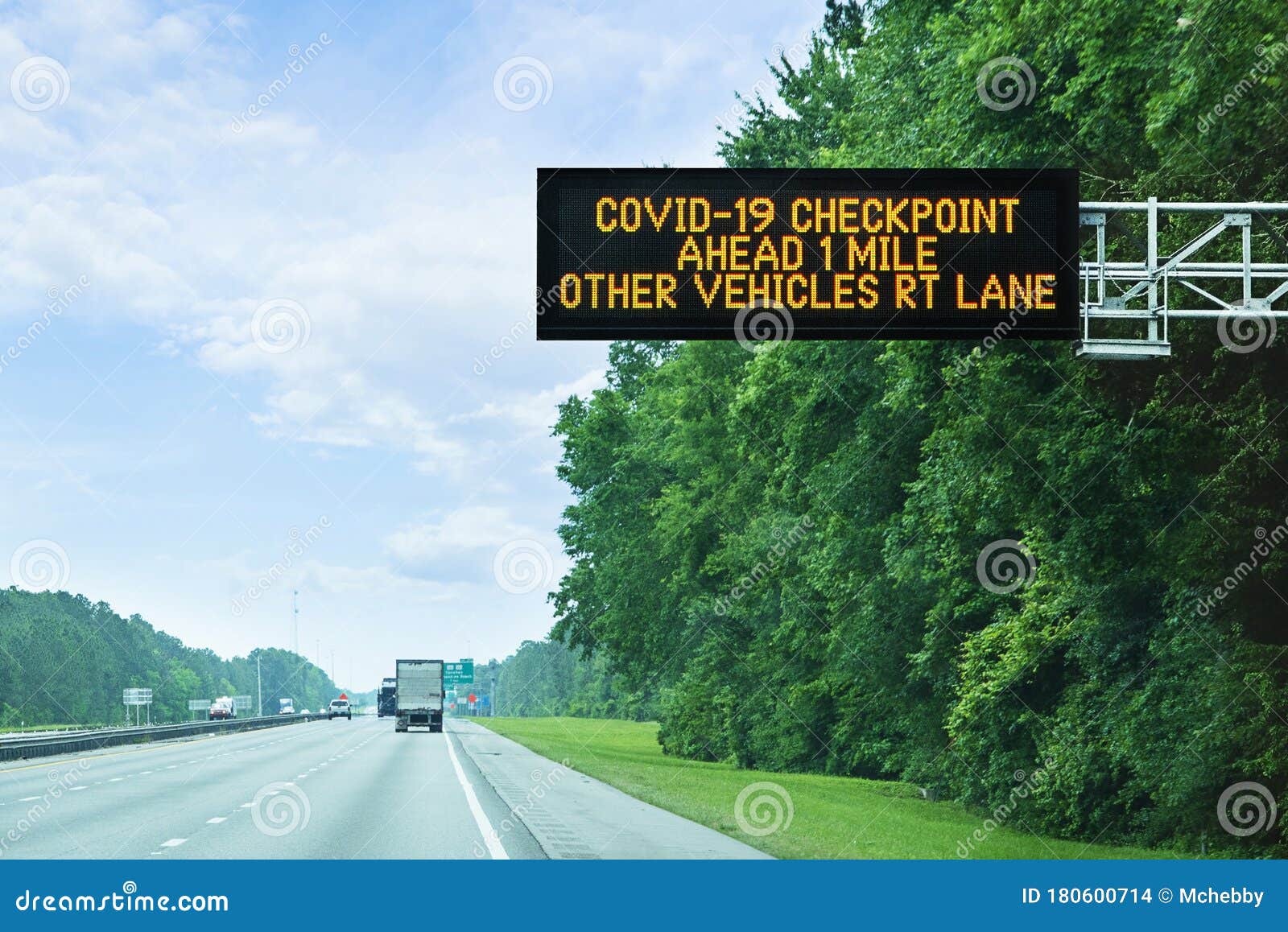 highway alert: covid-19 checkpoint ahead, overhead sign in florida on state border