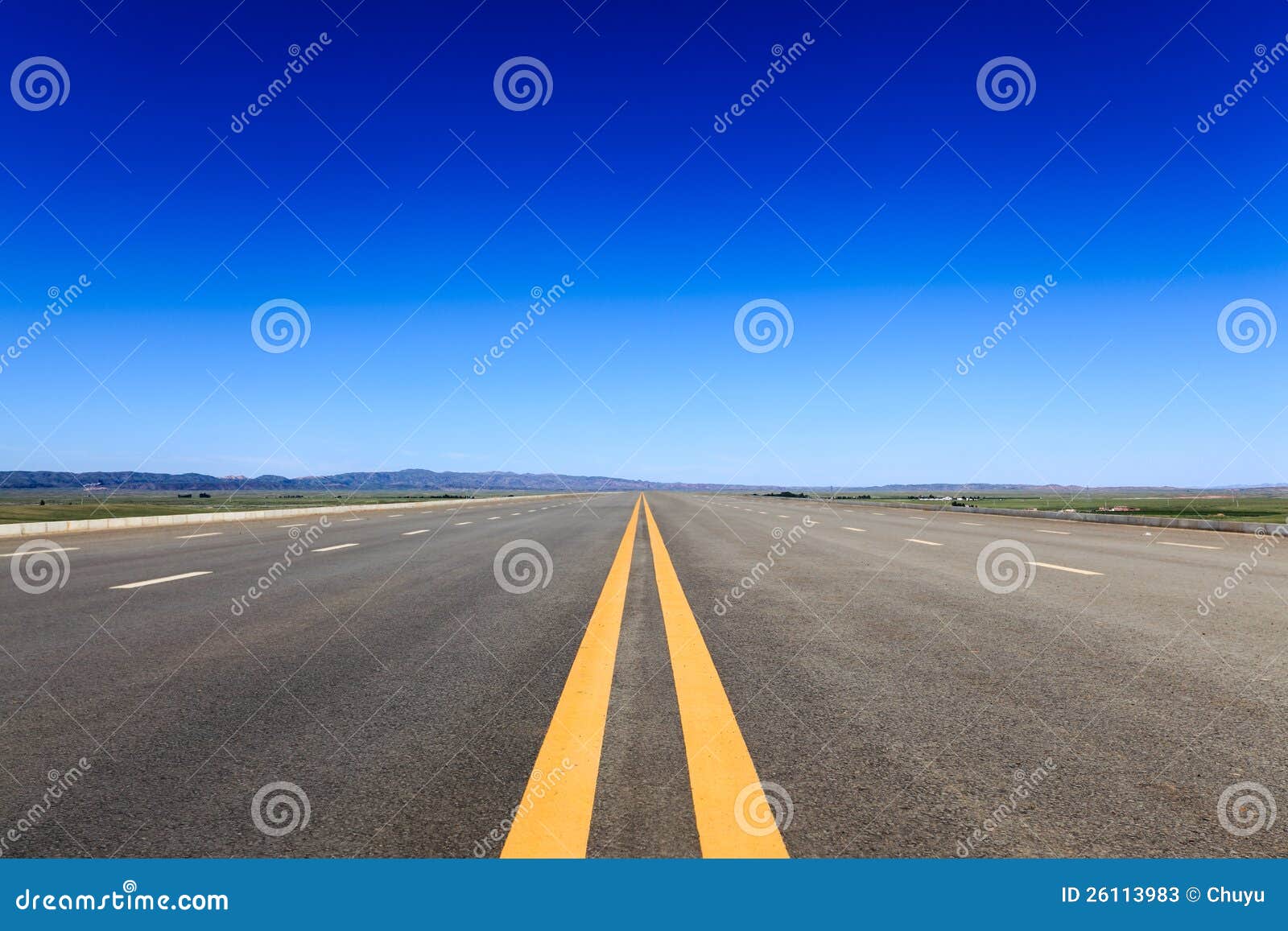 highway in steppe against a blue sky