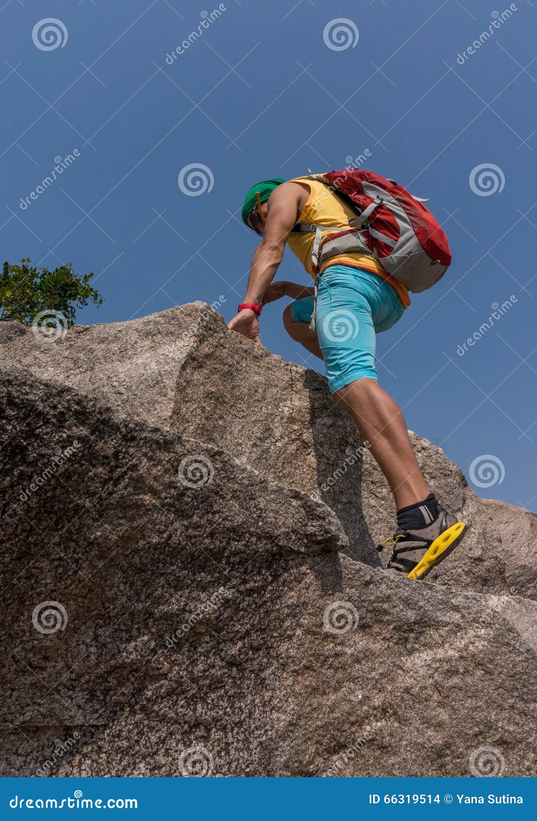 Hiker climbing on a rock stock photo. Image of mountain 66319514