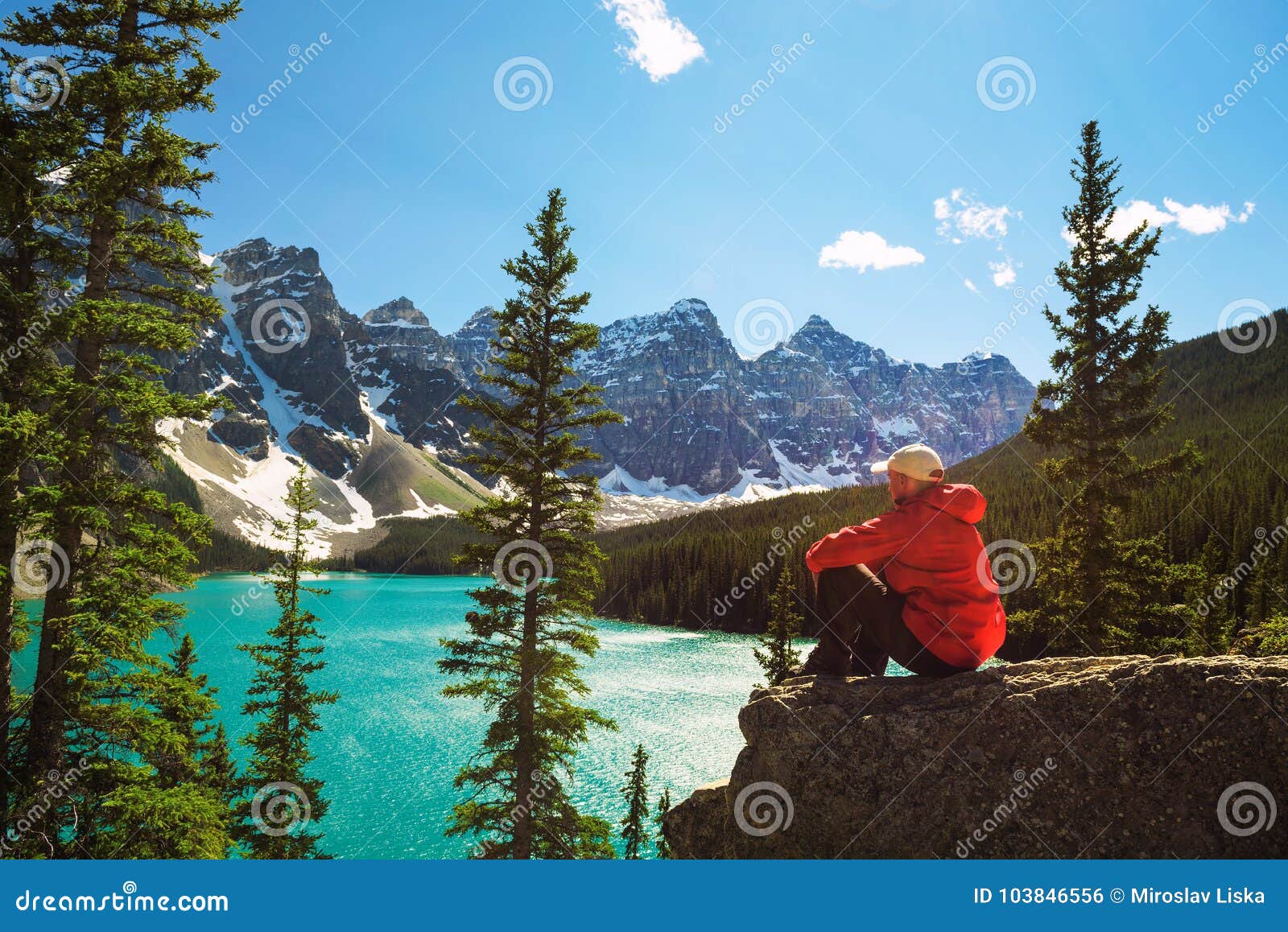 hiker enjoying the view of moraine lake in banff national park