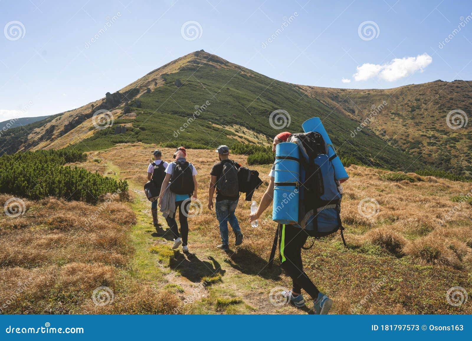 hiker goes to the mountains on a sunset hike. ecotourism