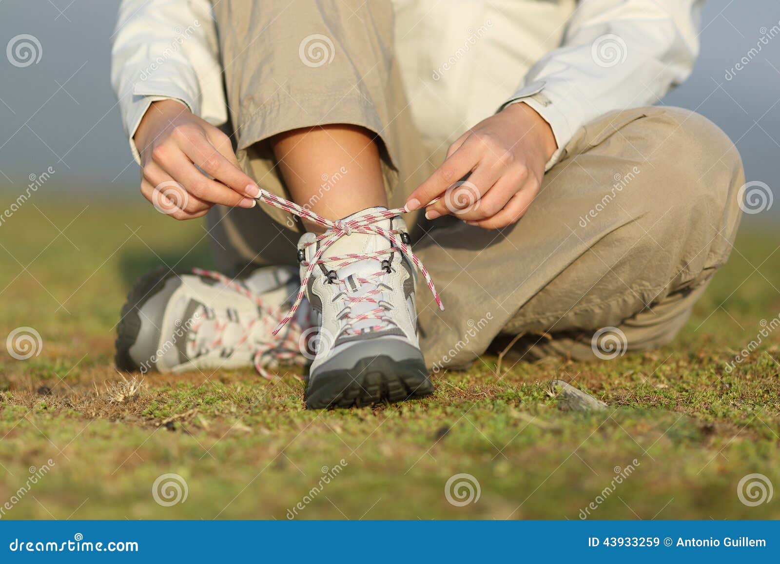 hiker woman tying shoelaces of boots