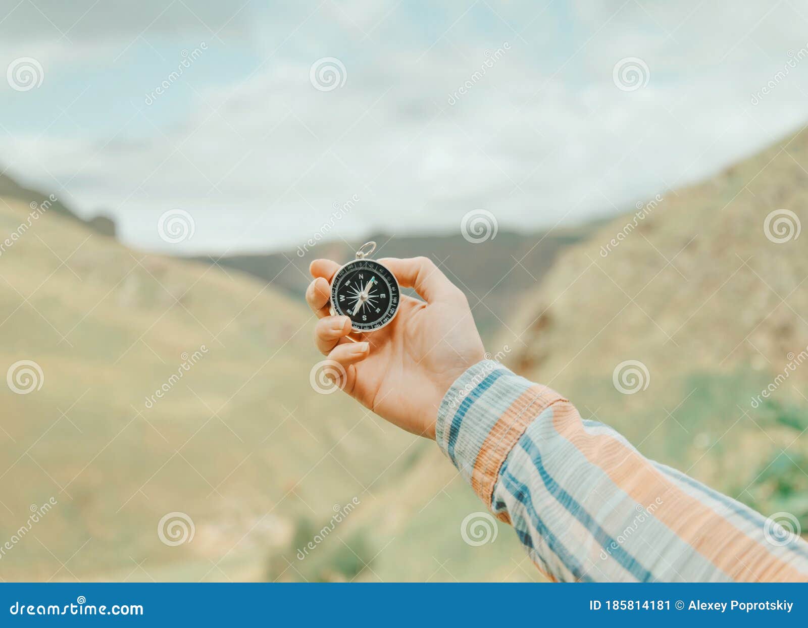 woman searching direction with a compass in mountains, pov.