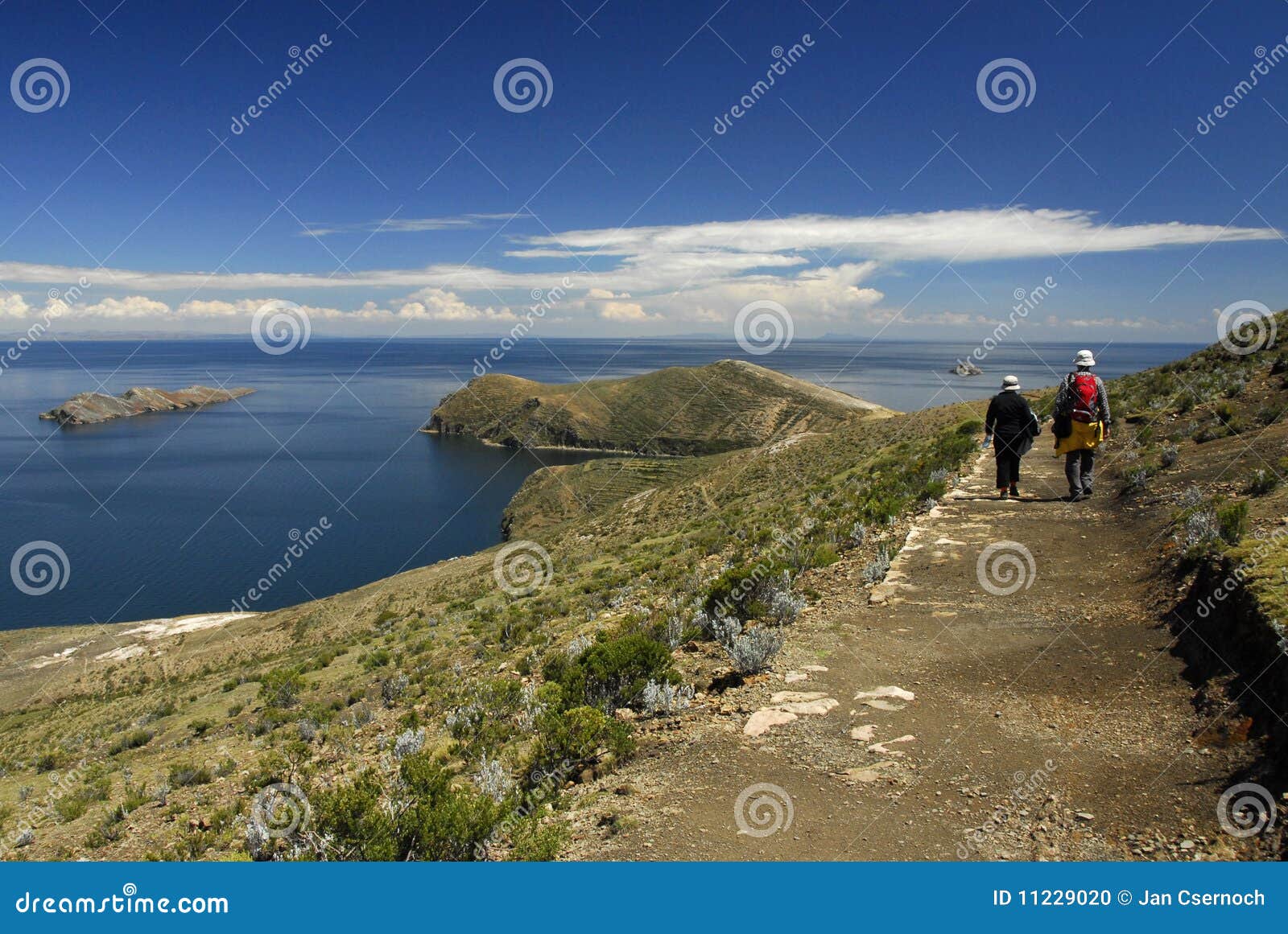 hikers on inca trail on isla del sol with titicaca