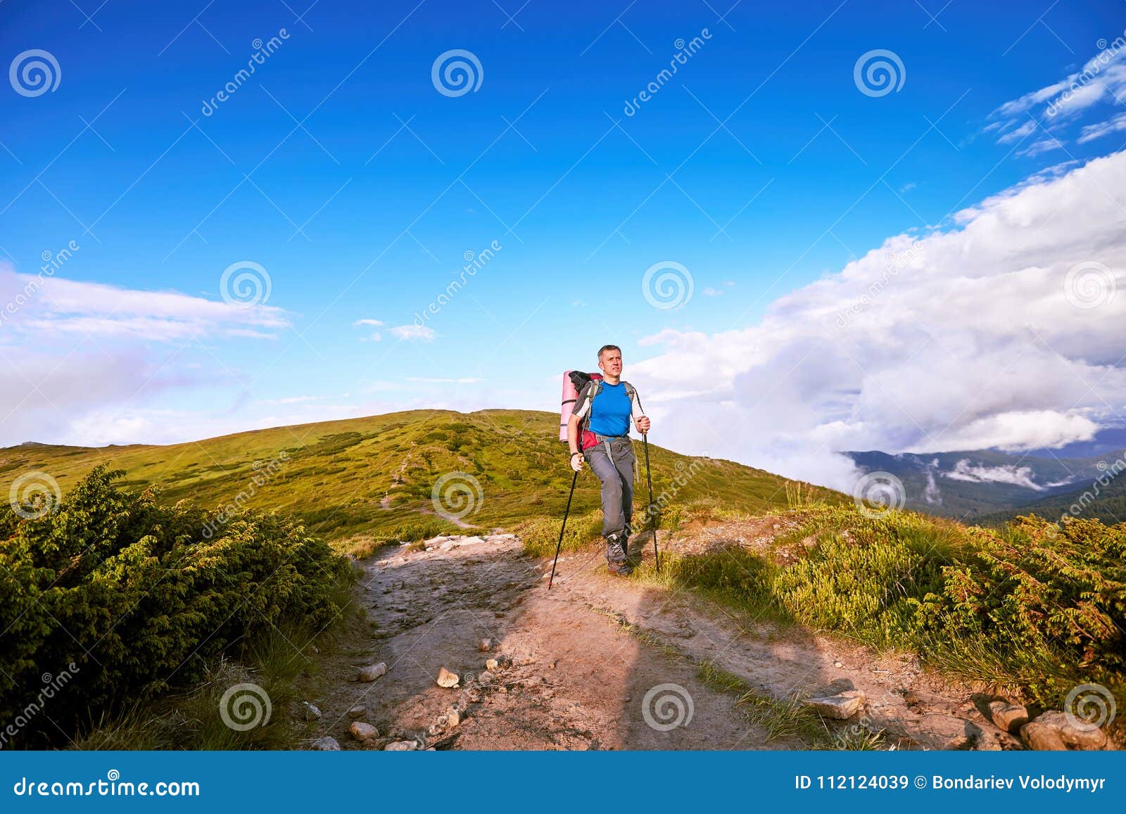 hiking in the mountains in the summer with a backpack.